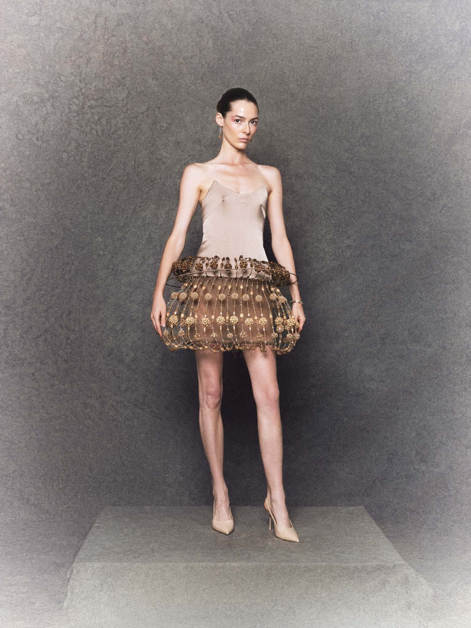 Brown silk sculptural mini dress with wooden beads, crystal accents and structure
