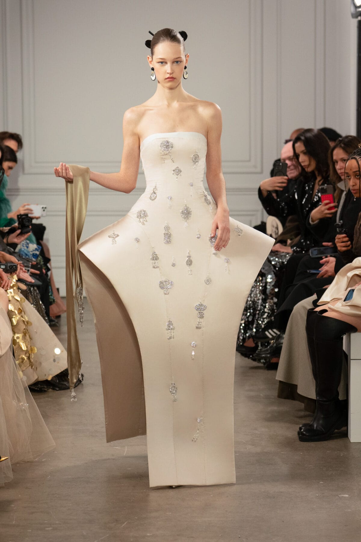 Ivory satin sculptural gown with architectural hips