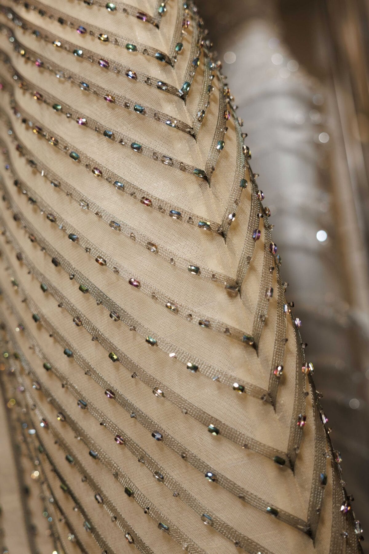 Strapless asymmetric column gown in taupe