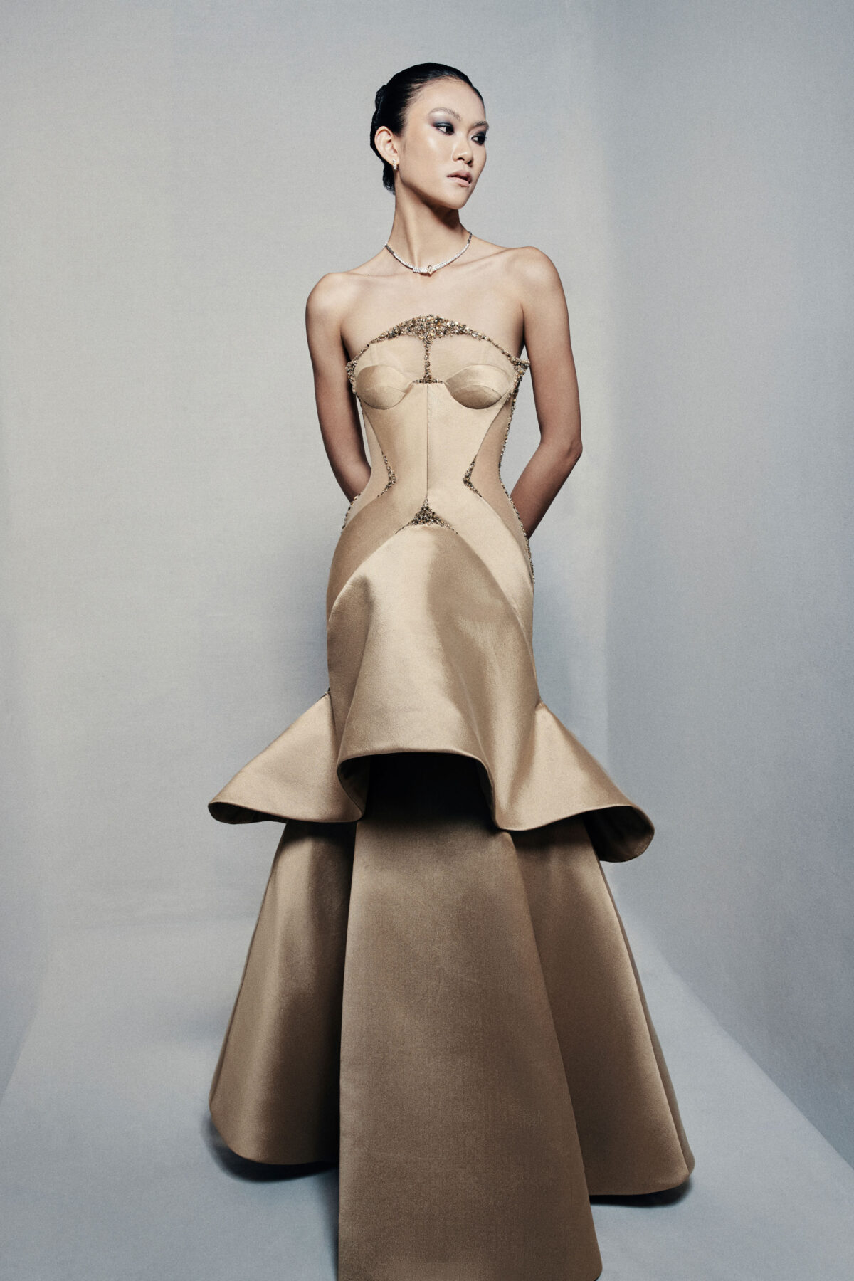 Strapless trumpet satin gown in golden beige
