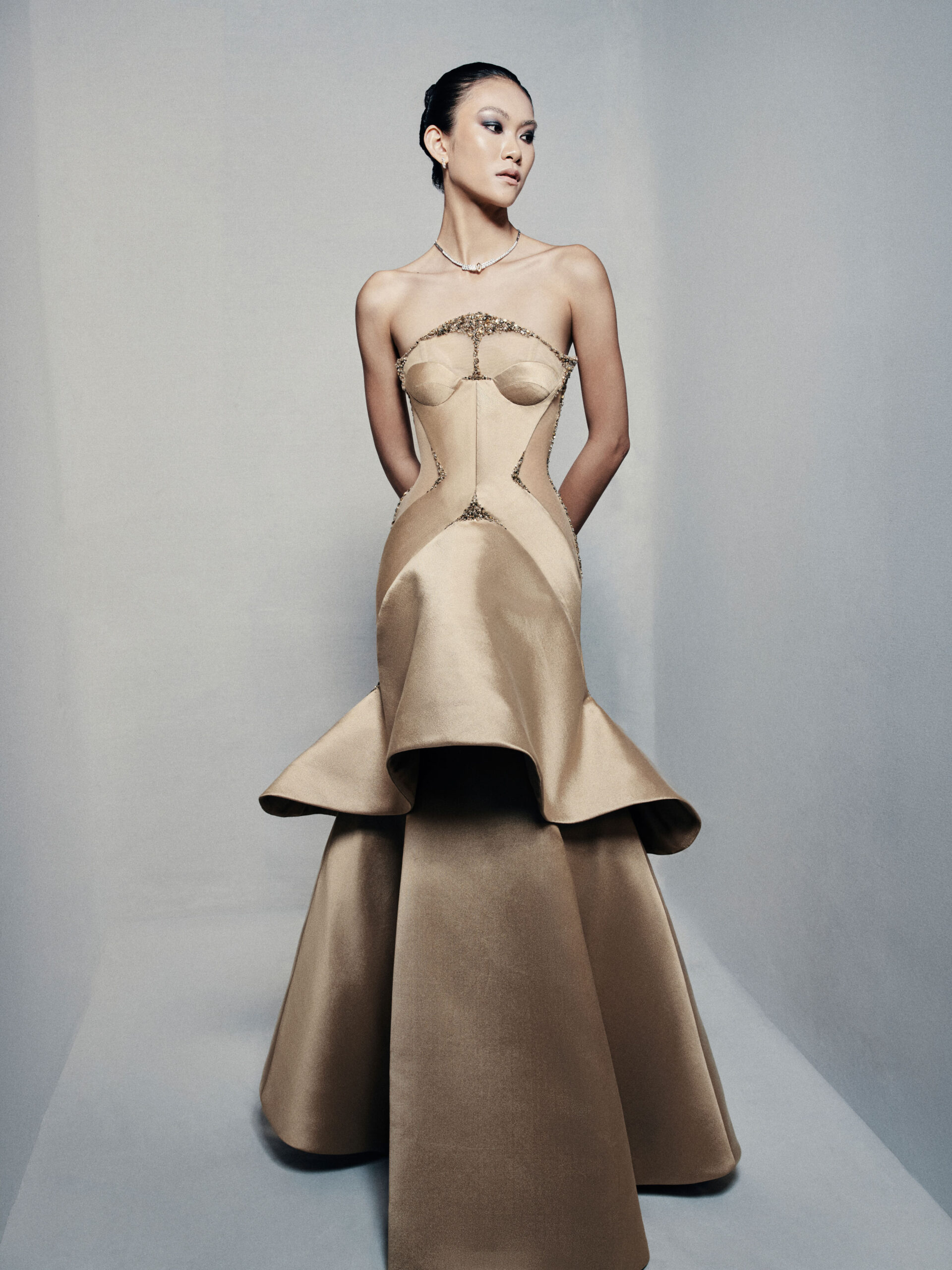 Strapless trumpet satin gown in golden beige