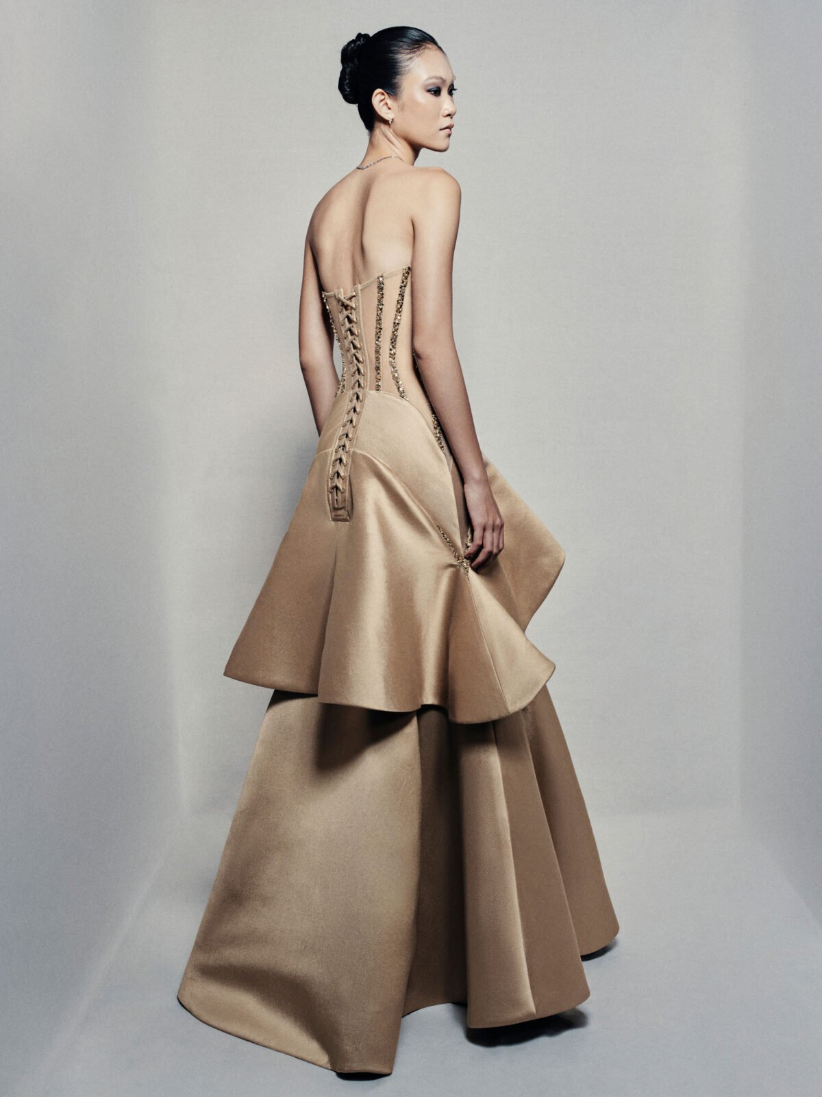 Strapless trumpet satin gown in golden beige