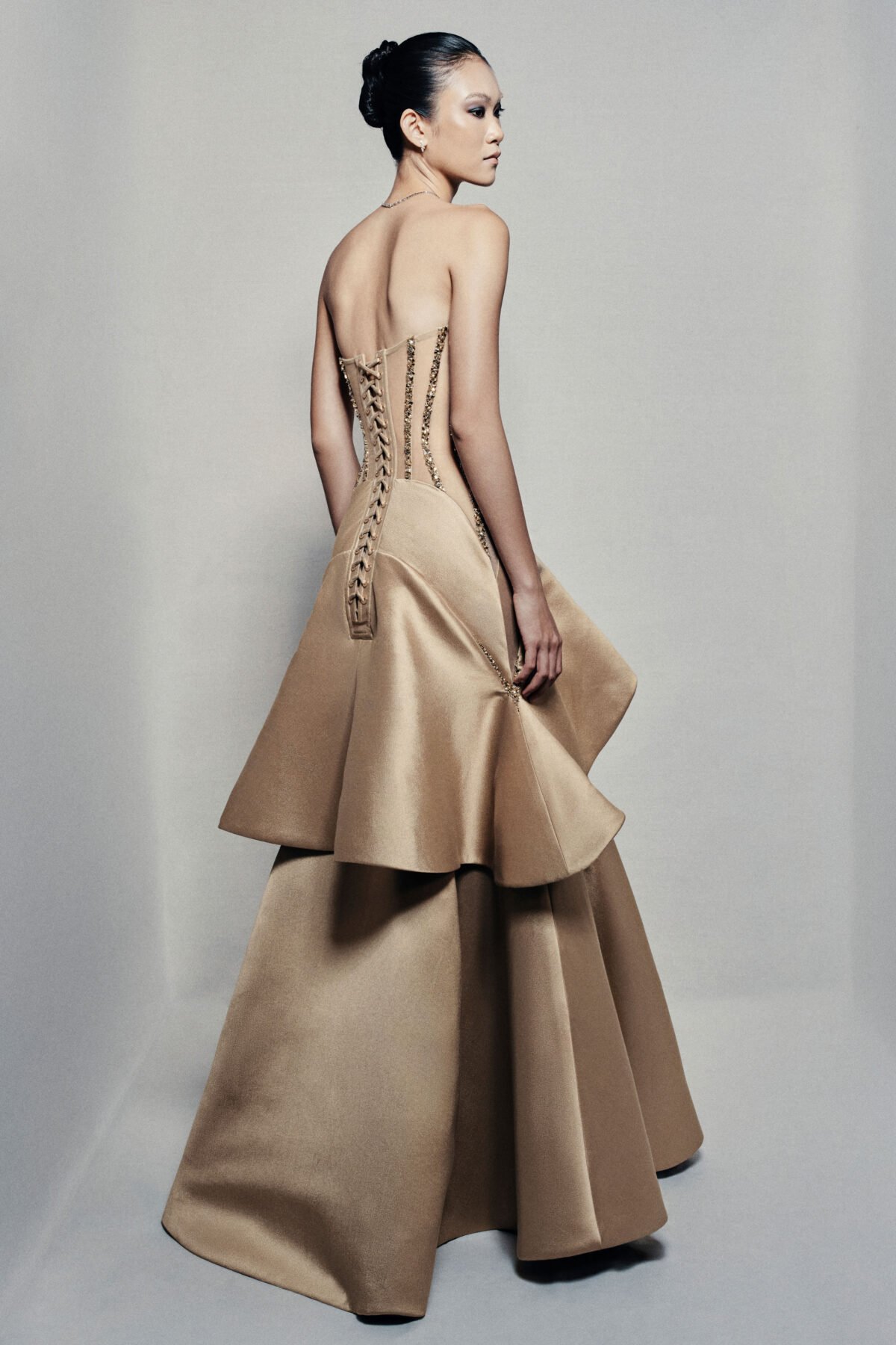Strapless trumpet satin gown in golden beige