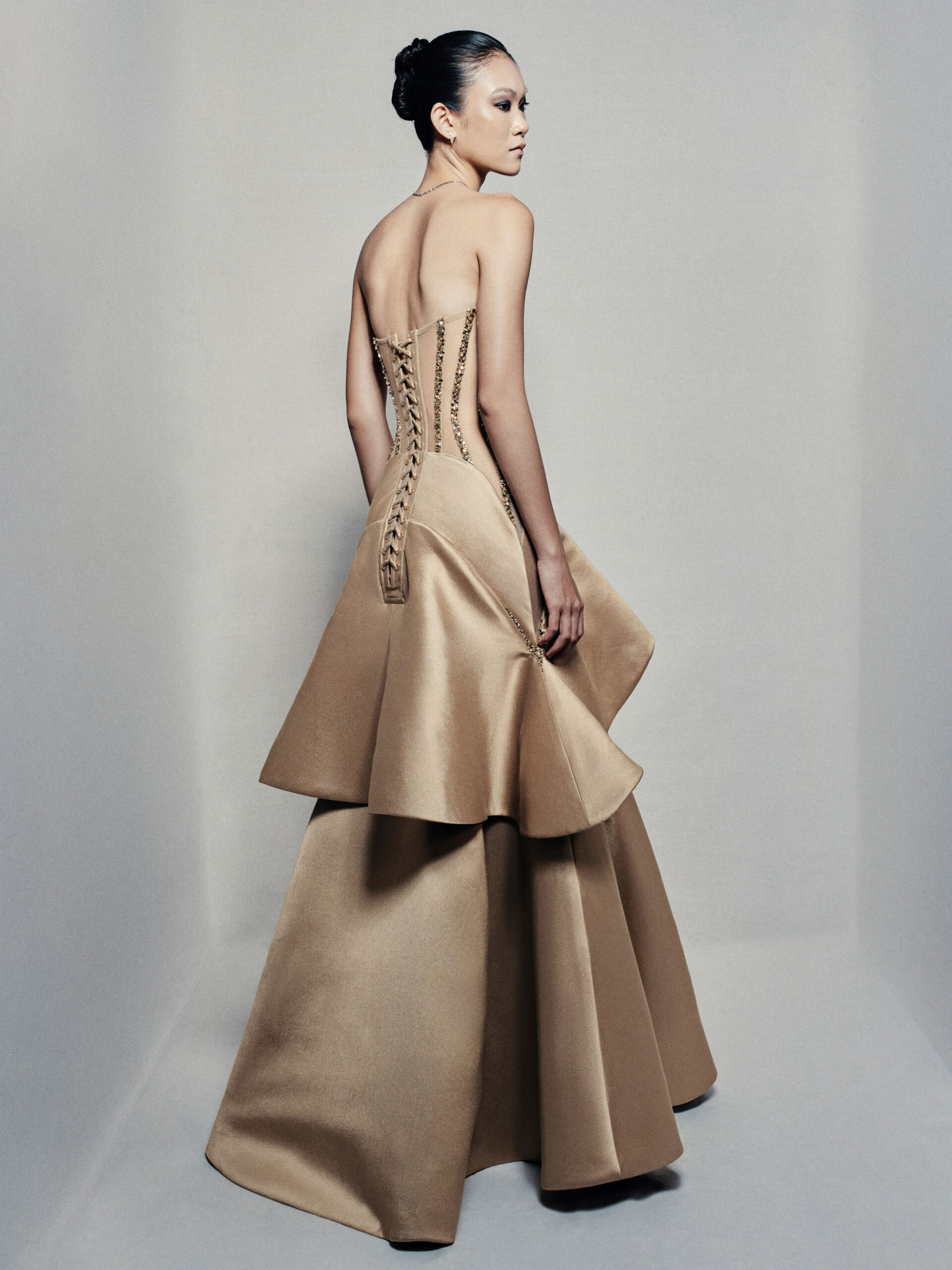 Strapless trumpet satin gown in golden beige