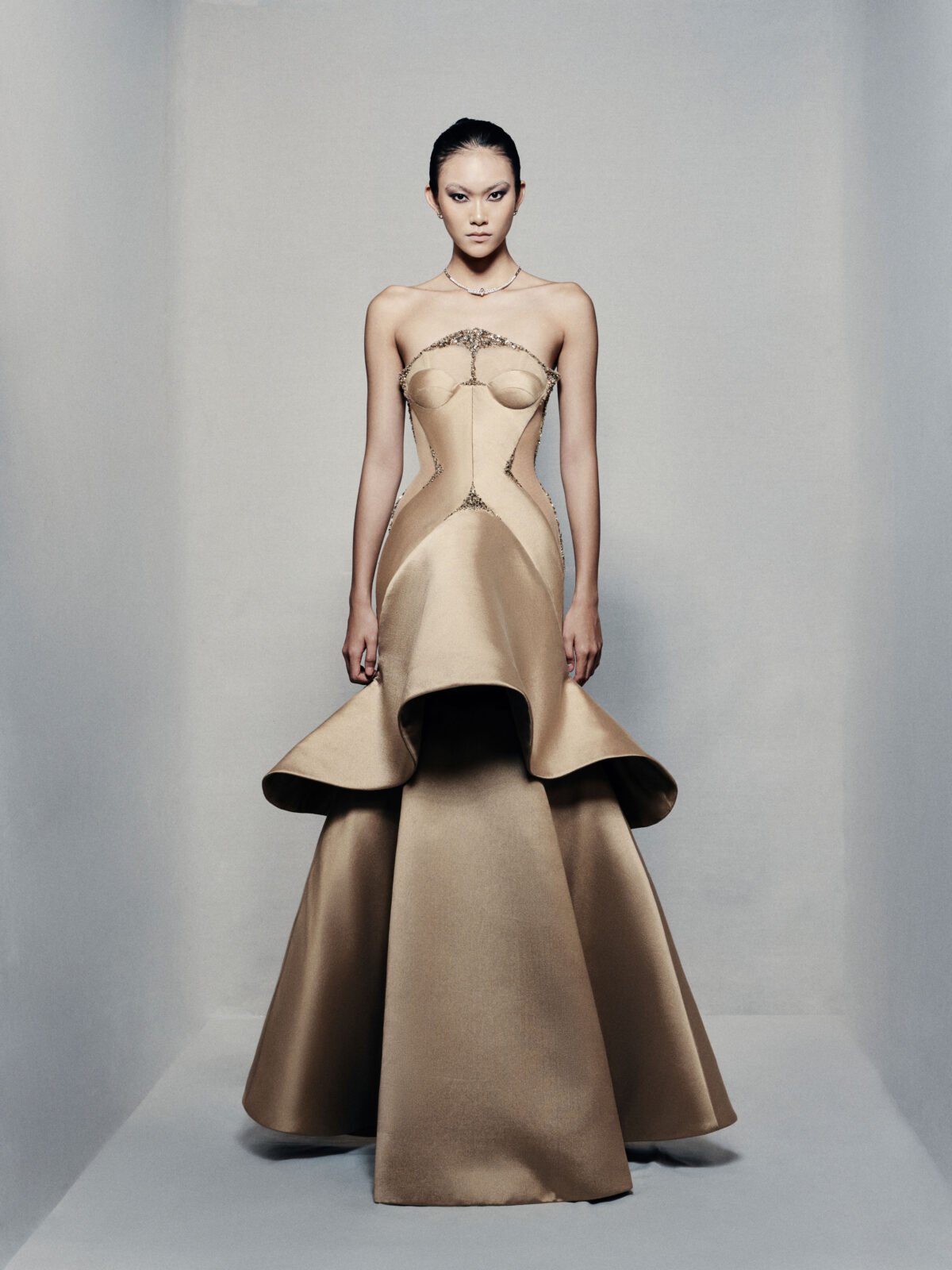 Strapless trumpet satin gown in golden beige