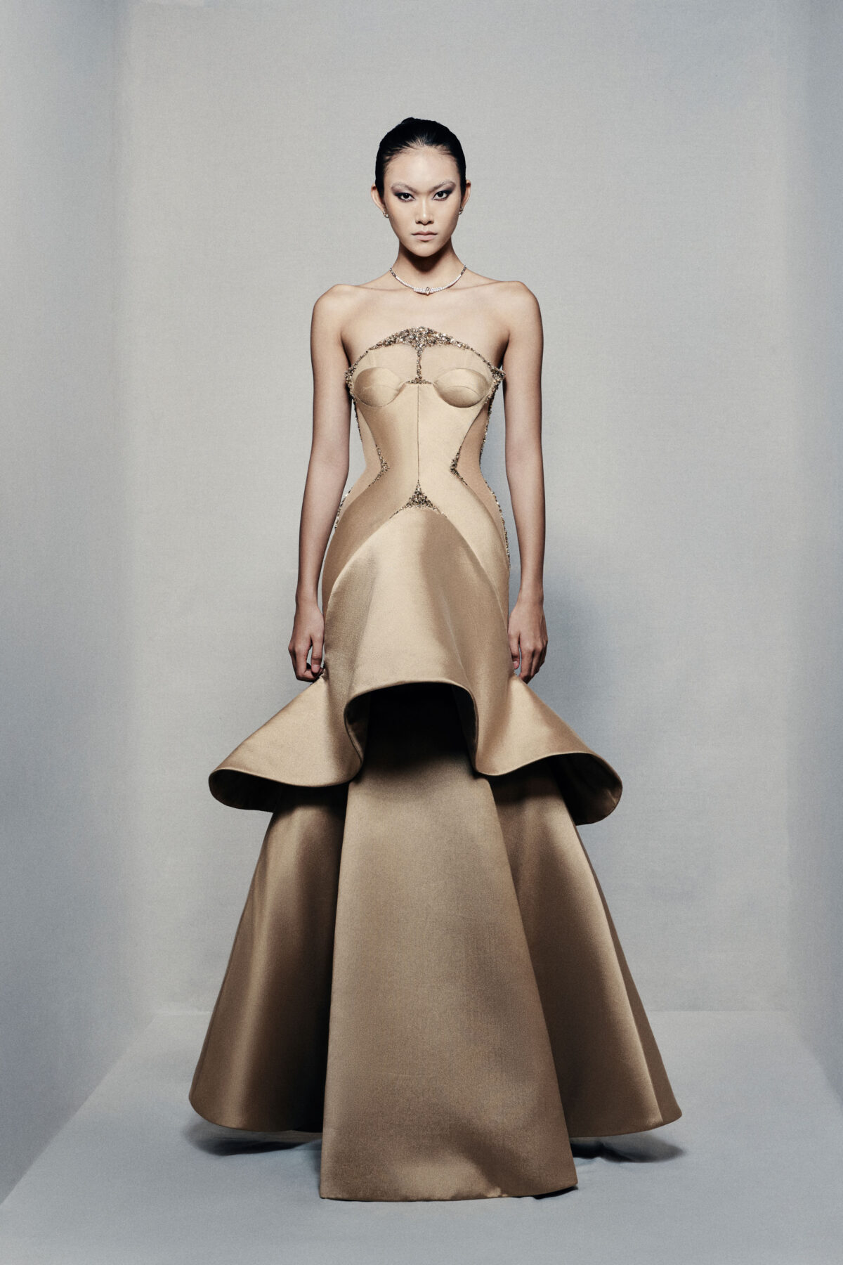 Strapless trumpet satin gown in golden beige