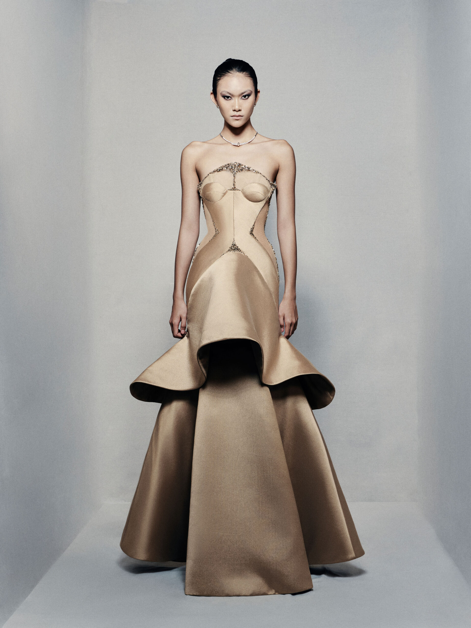 Strapless trumpet satin gown in golden beige