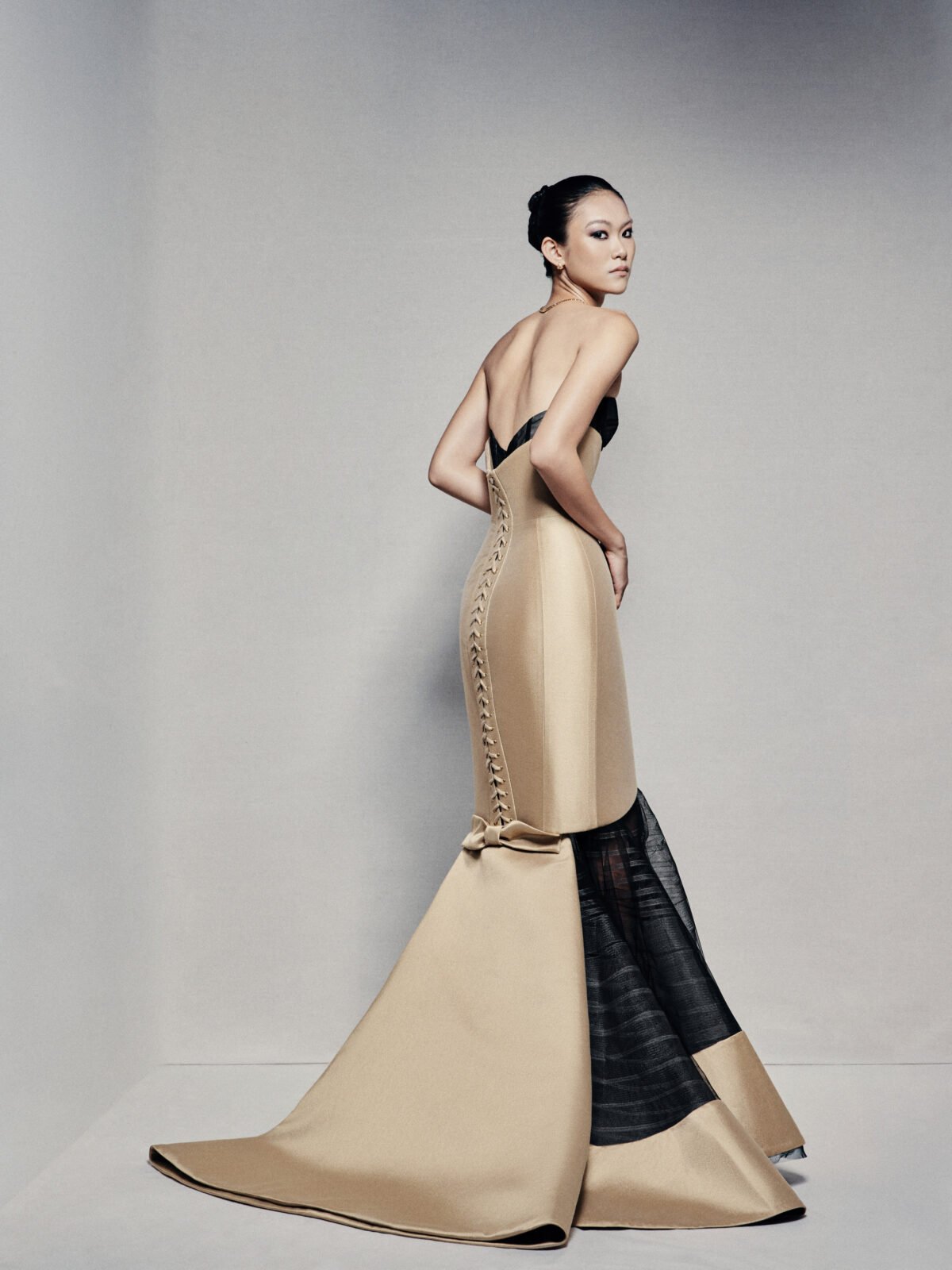 Black and gold strapless mermaid gown with visible corset