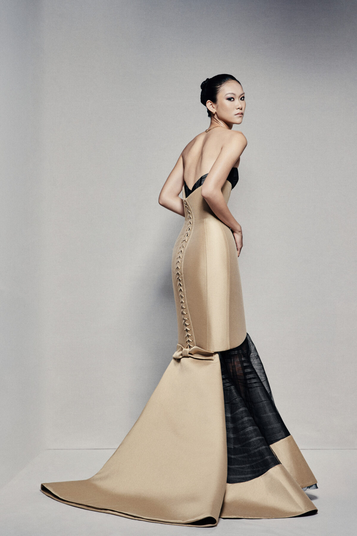 Black and gold strapless mermaid gown with visible corset
