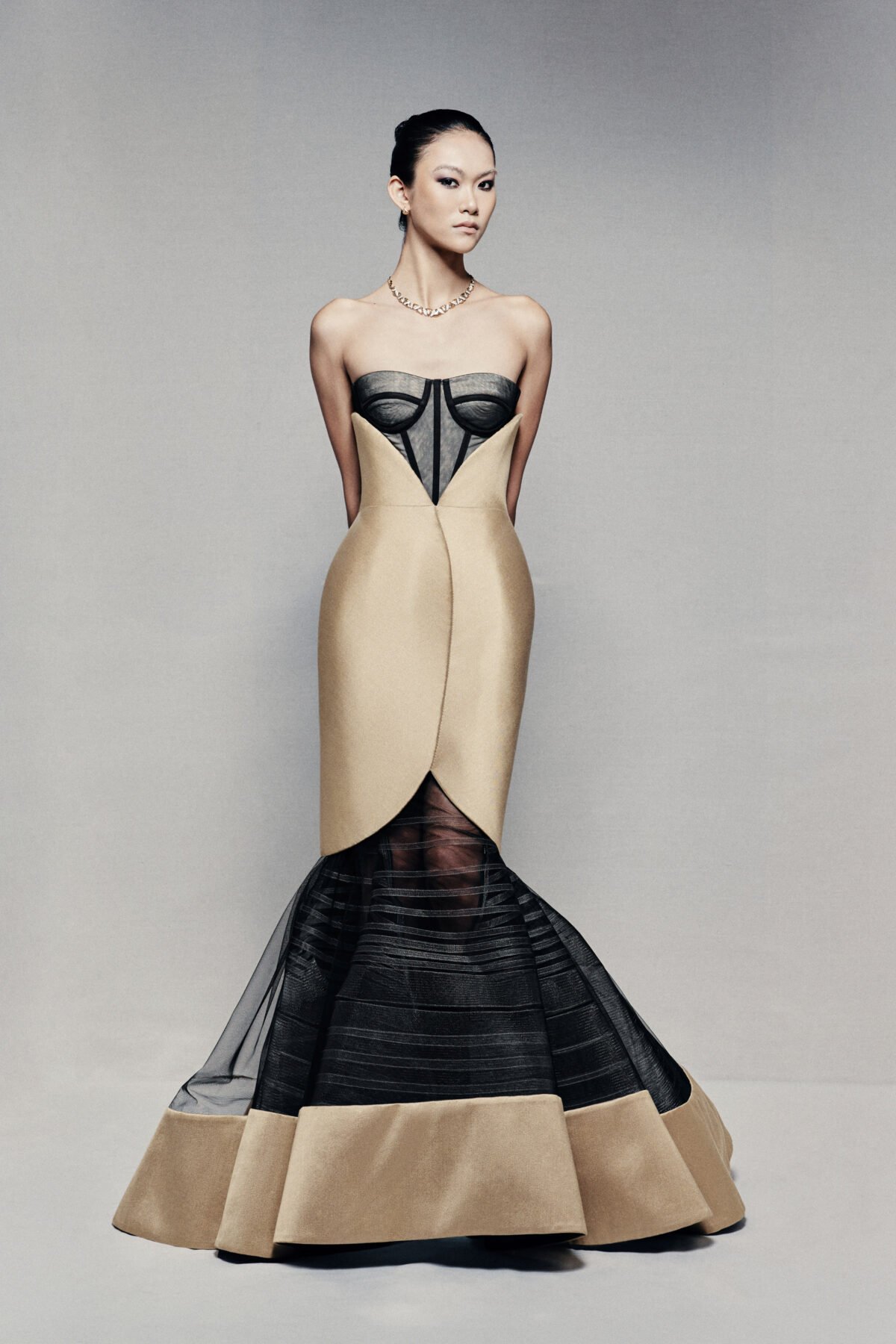 Black and gold strapless mermaid gown with visible corset