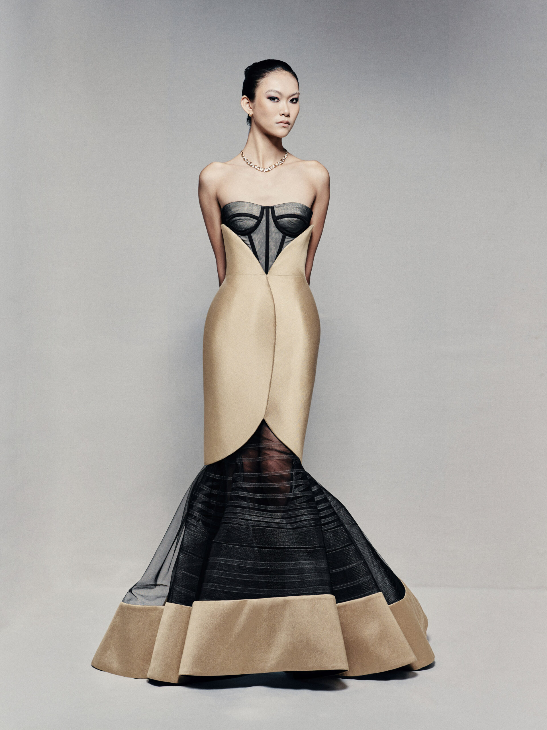 Black and gold strapless mermaid gown with visible corset