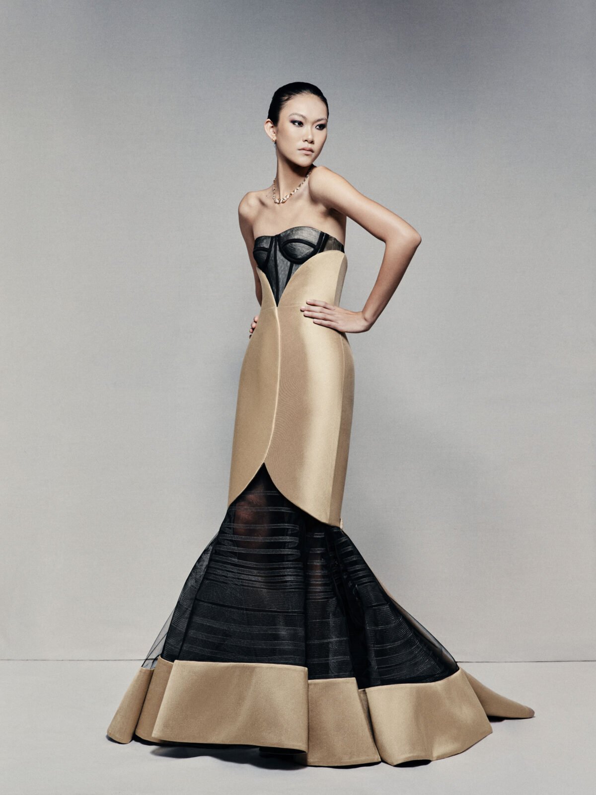 Black and gold strapless mermaid gown with visible corset