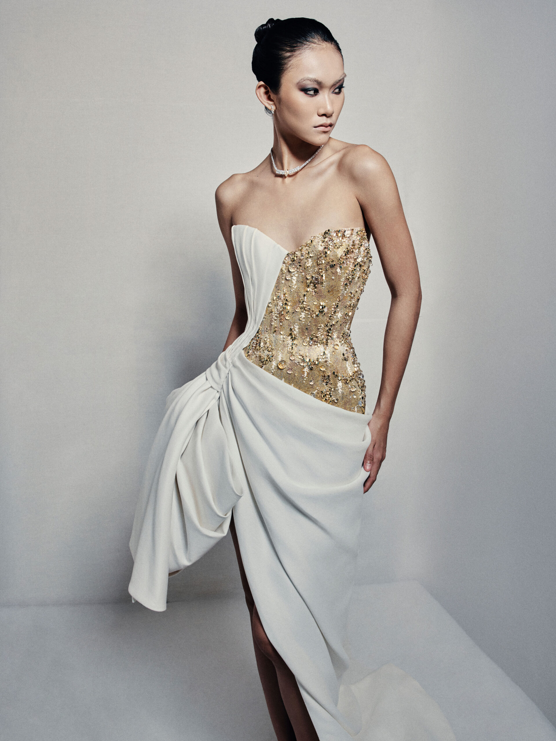 Asymmetrical strapless evening dress with sculptural taffeta drapes