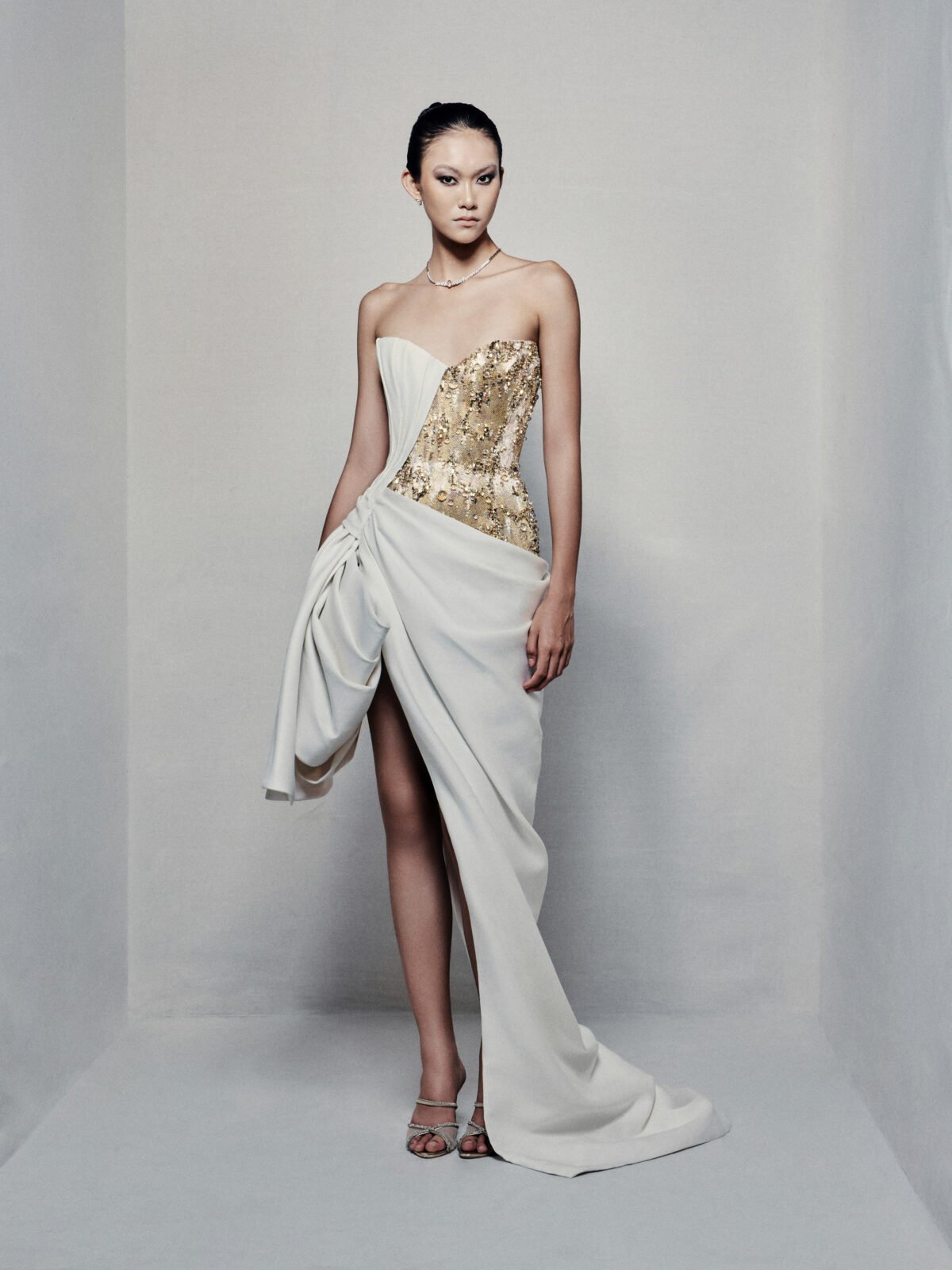 Asymmetrical strapless evening dress with sculptural taffeta drapes