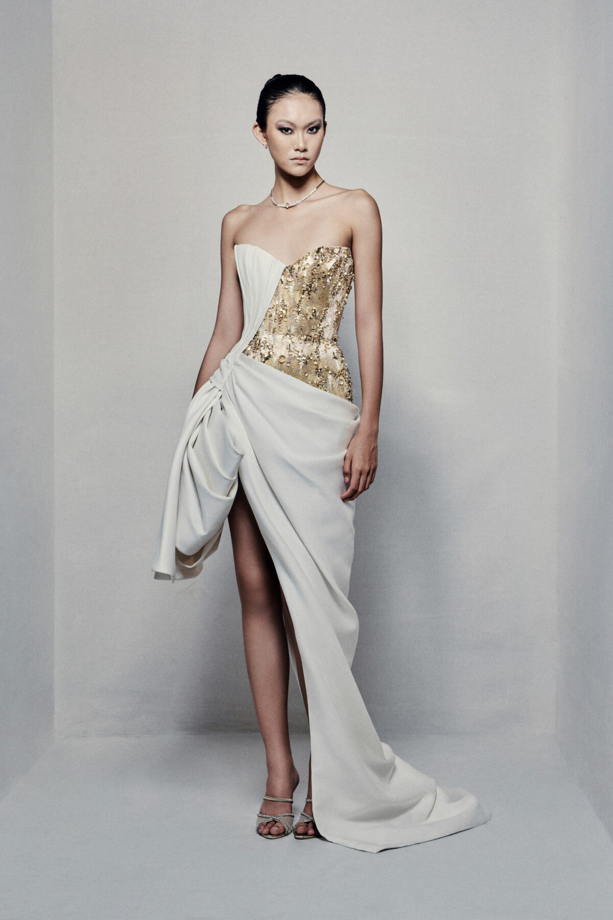 Asymmetrical strapless evening dress with sculptural taffeta drapes