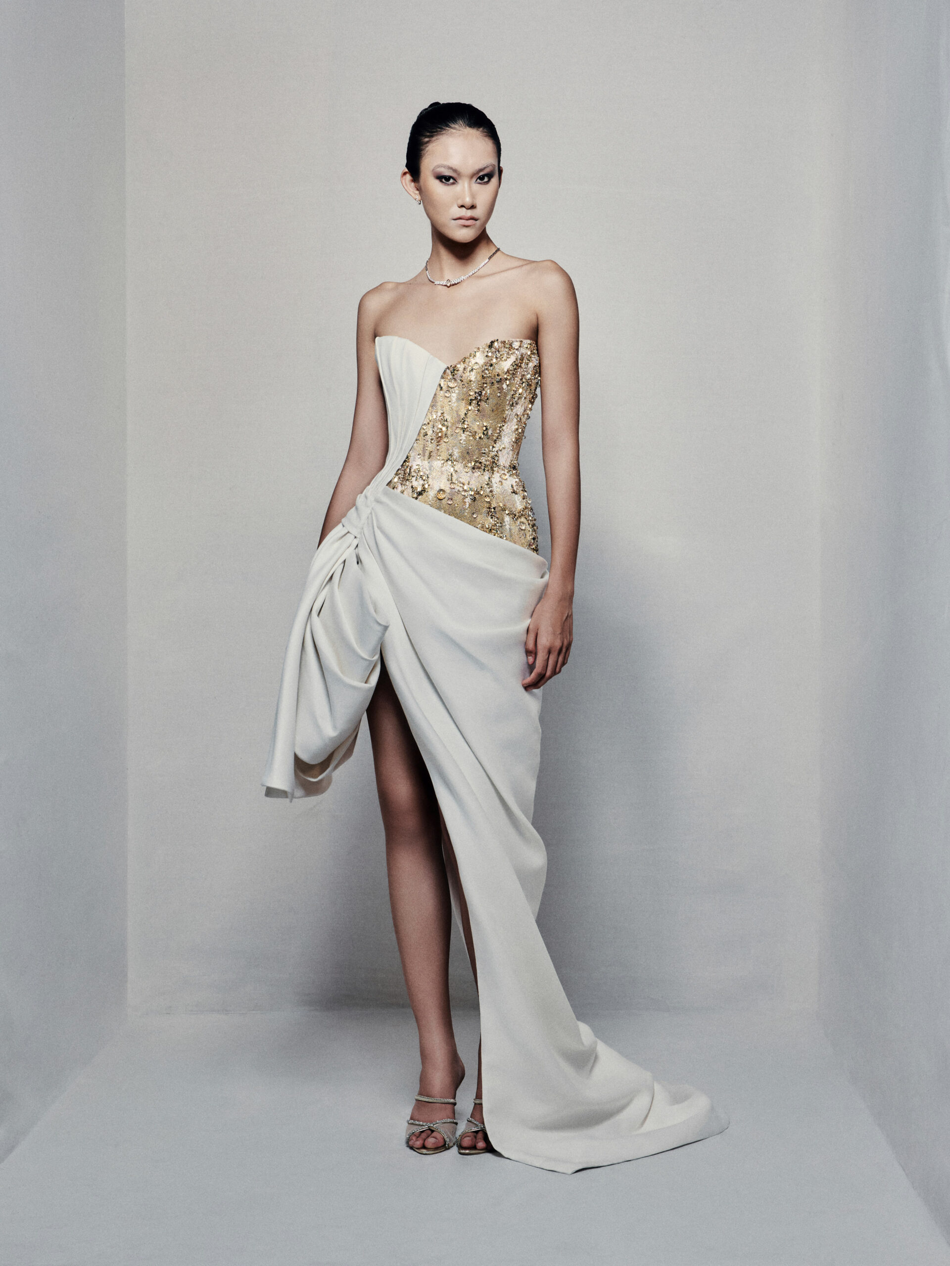 Asymmetrical strapless evening dress with sculptural taffeta drapes