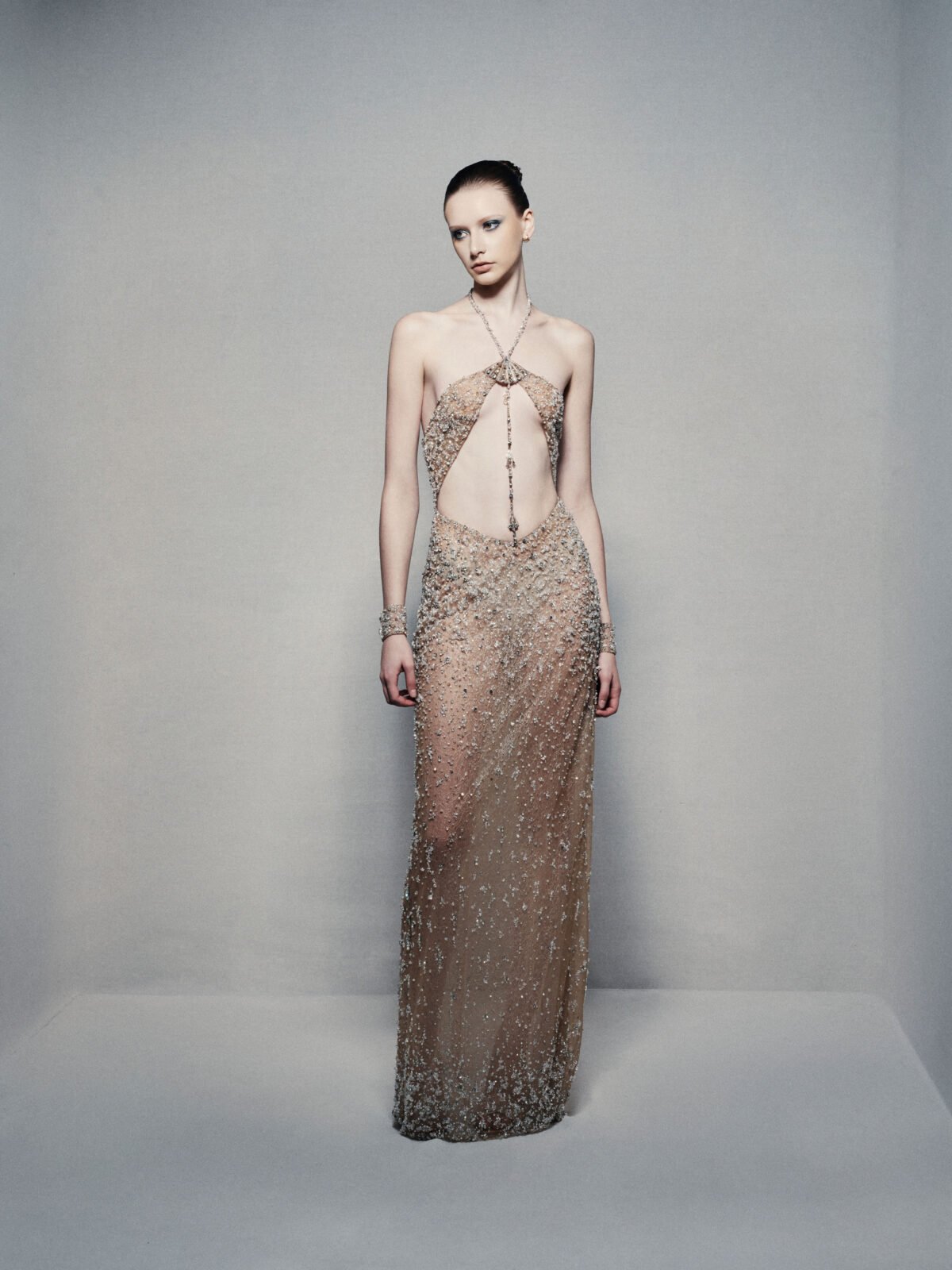 Semi-sheer halterneck column gown in champagne gold
