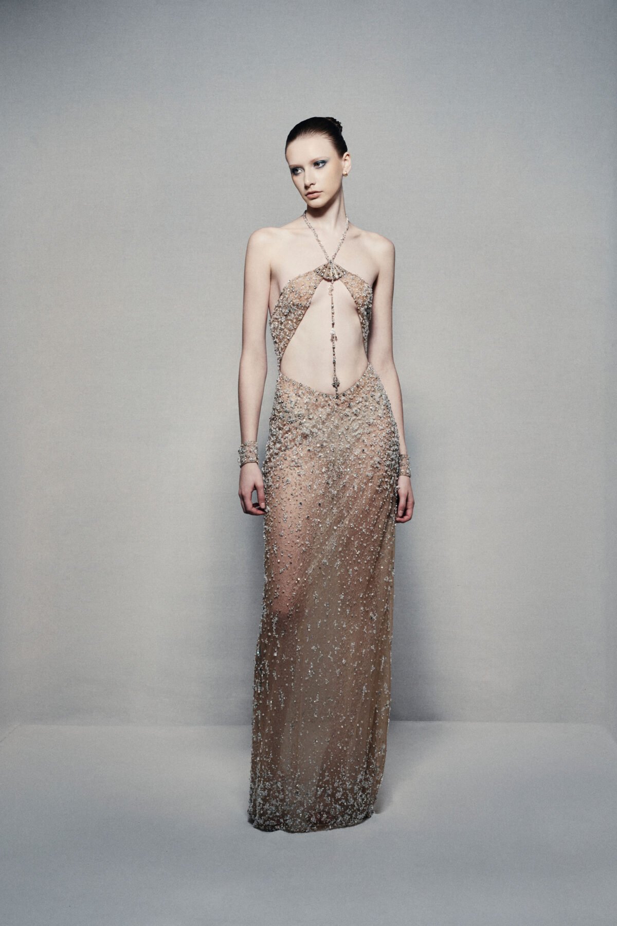 Semi-sheer halterneck column gown in champagne gold