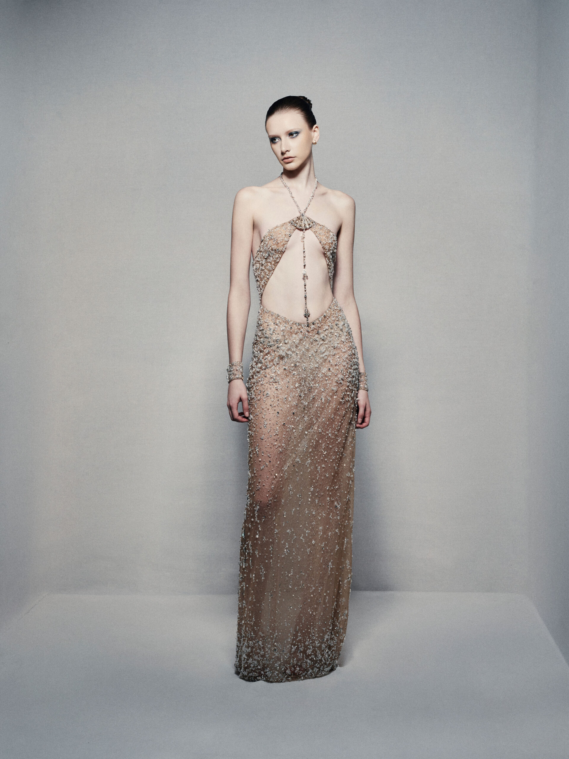 Semi-sheer halterneck column gown in champagne gold