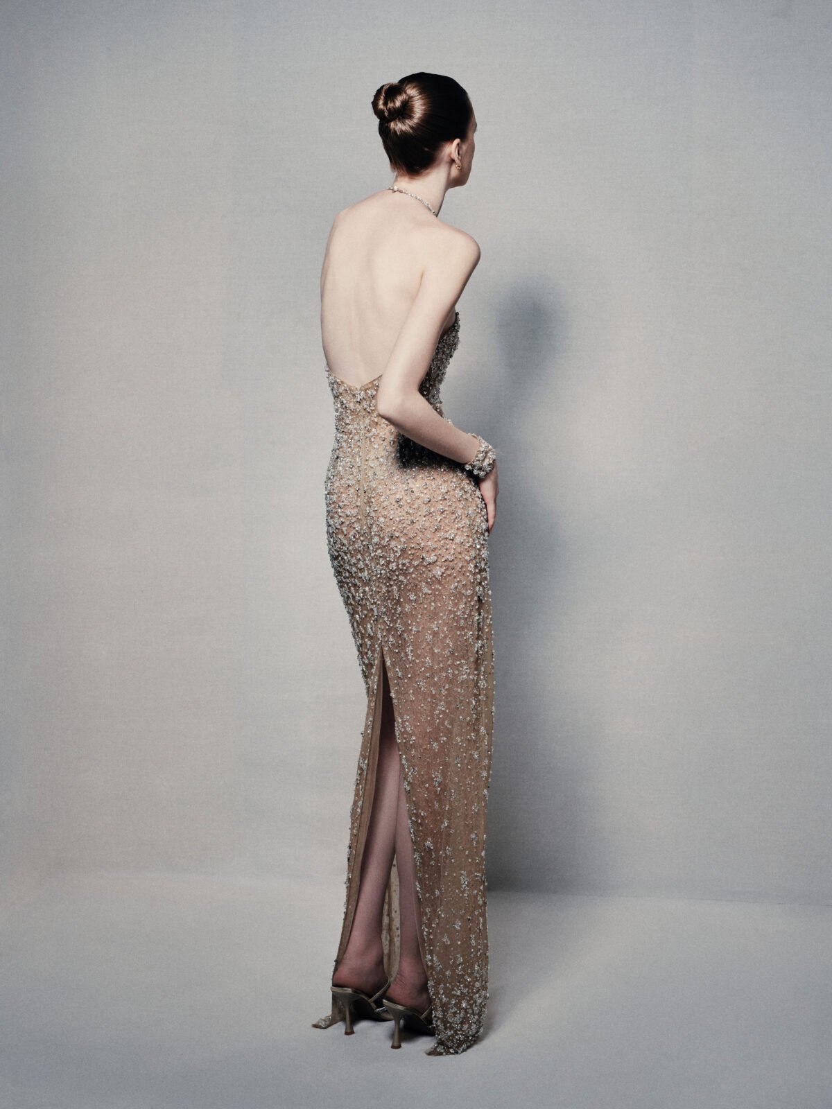 Semi-sheer halterneck column gown in champagne gold