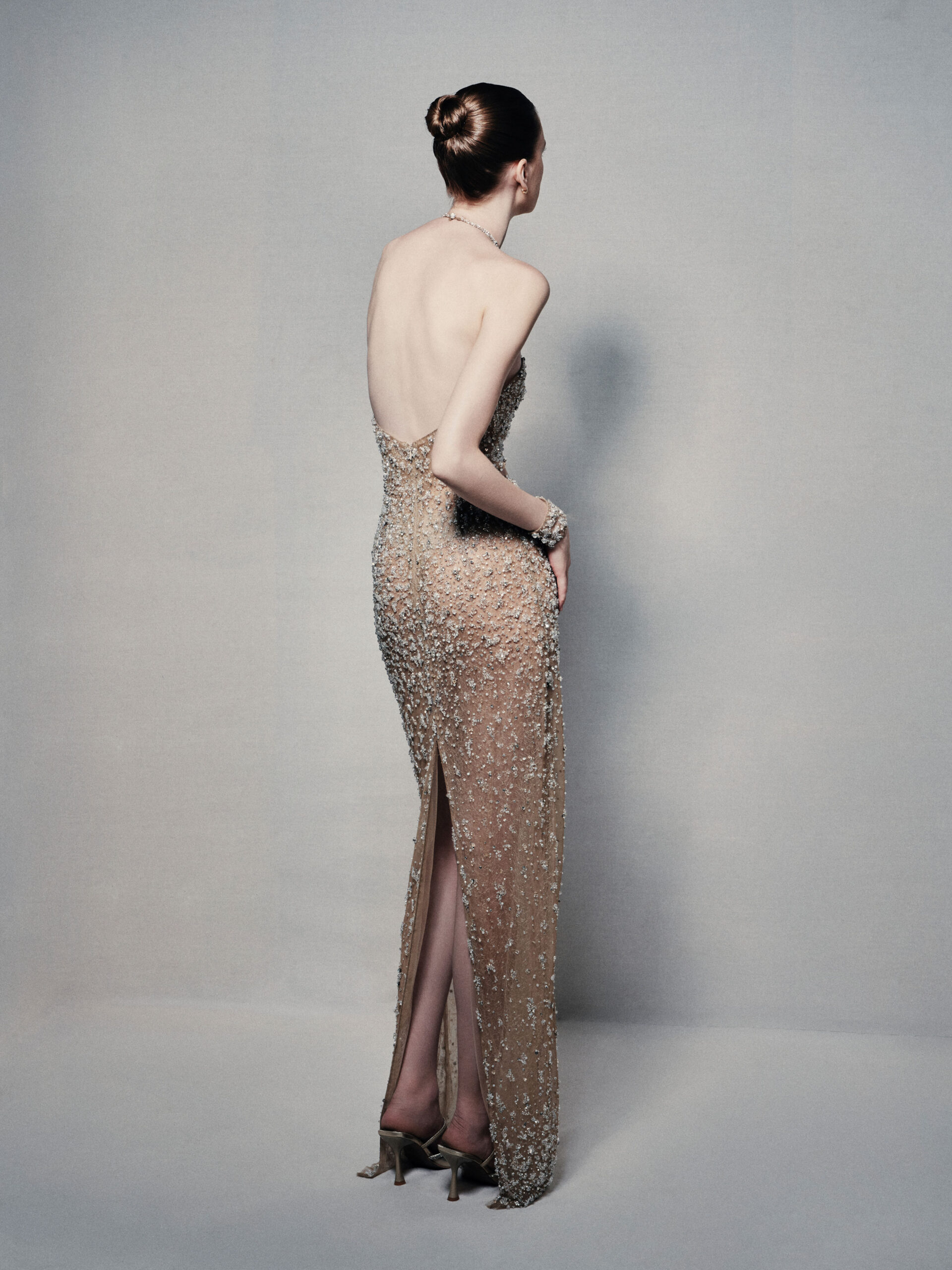 Semi-sheer halterneck column gown in champagne gold