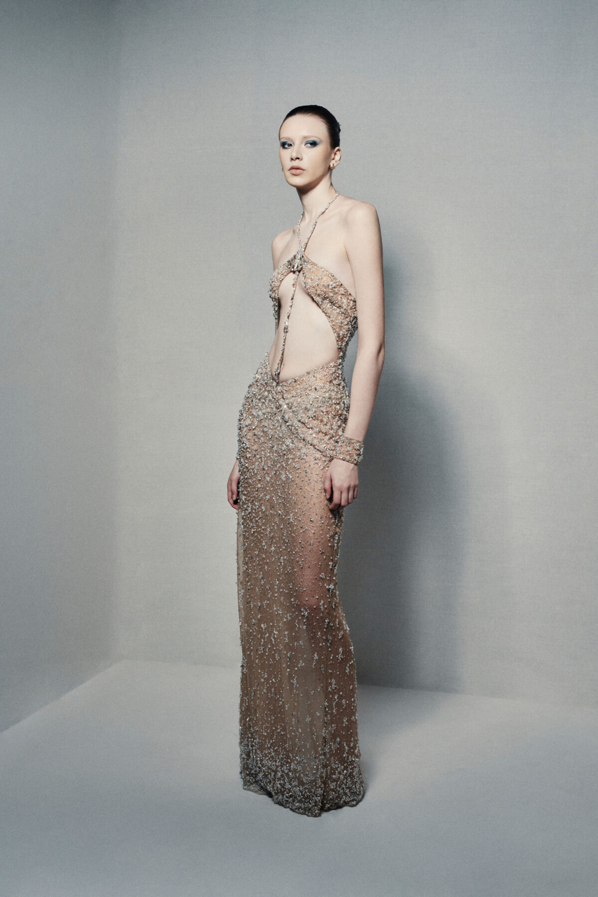 Semi-sheer halterneck column gown in champagne gold