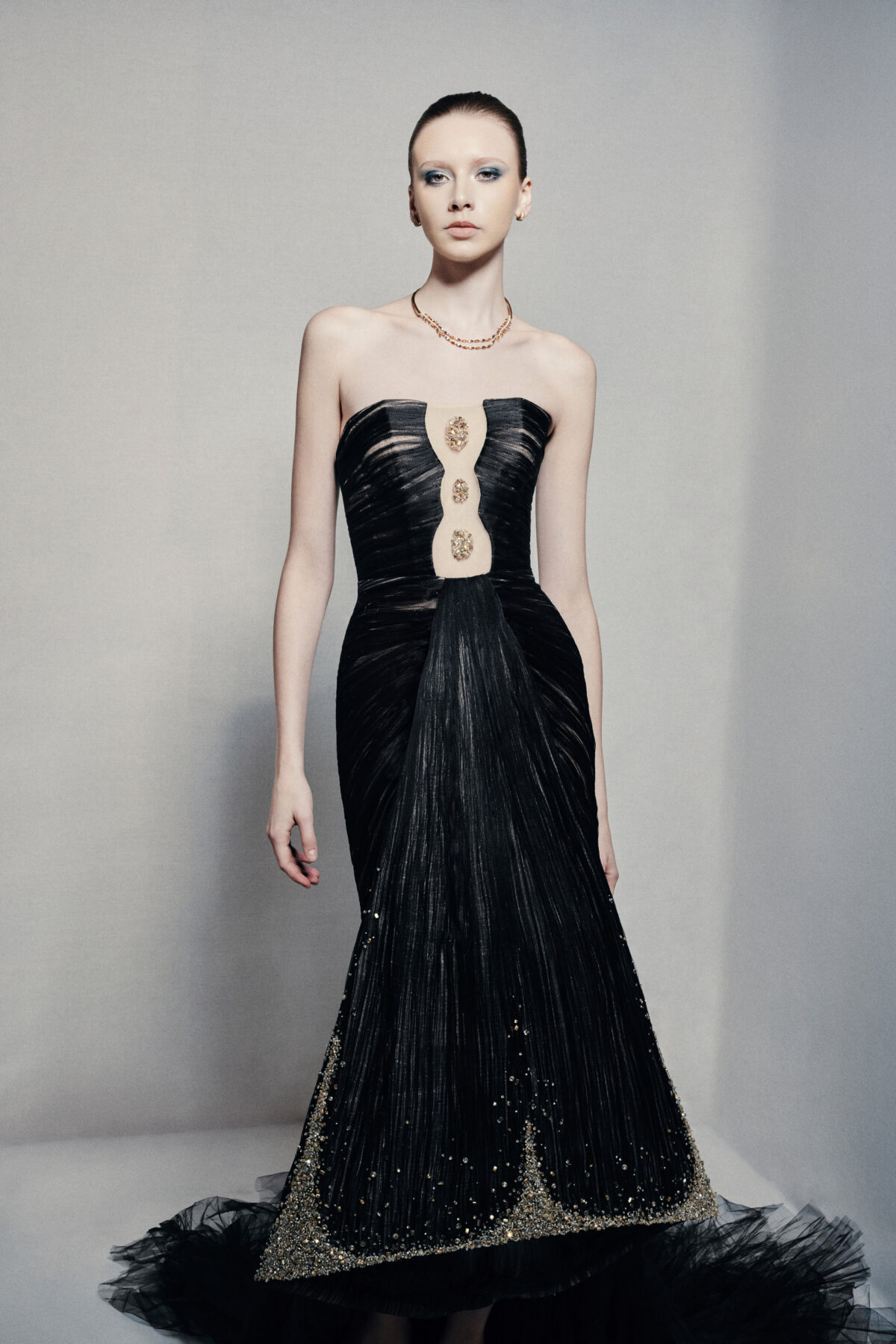 Black strapless mermaid gown with gold embellishments