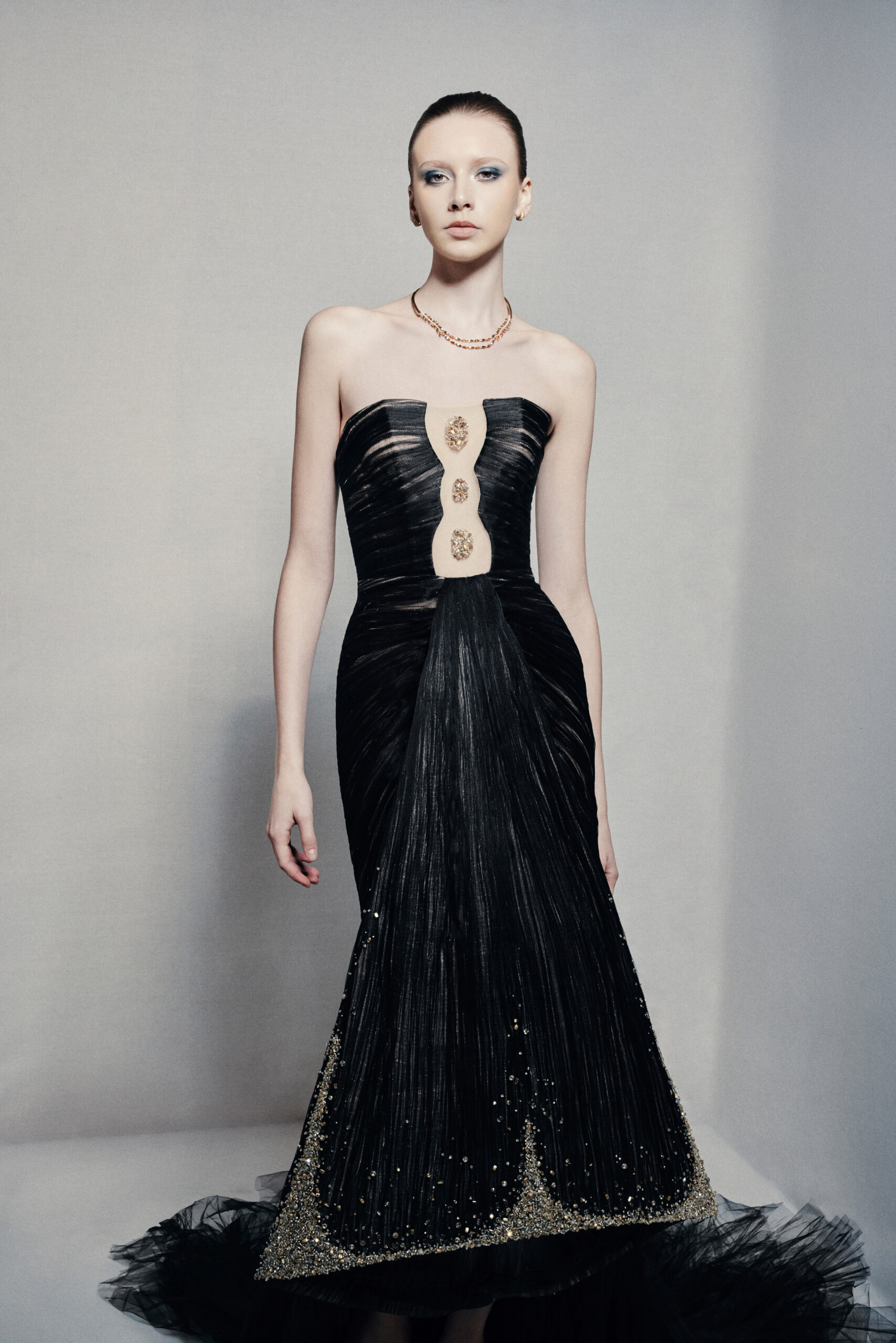 Black strapless mermaid gown with gold embellishments