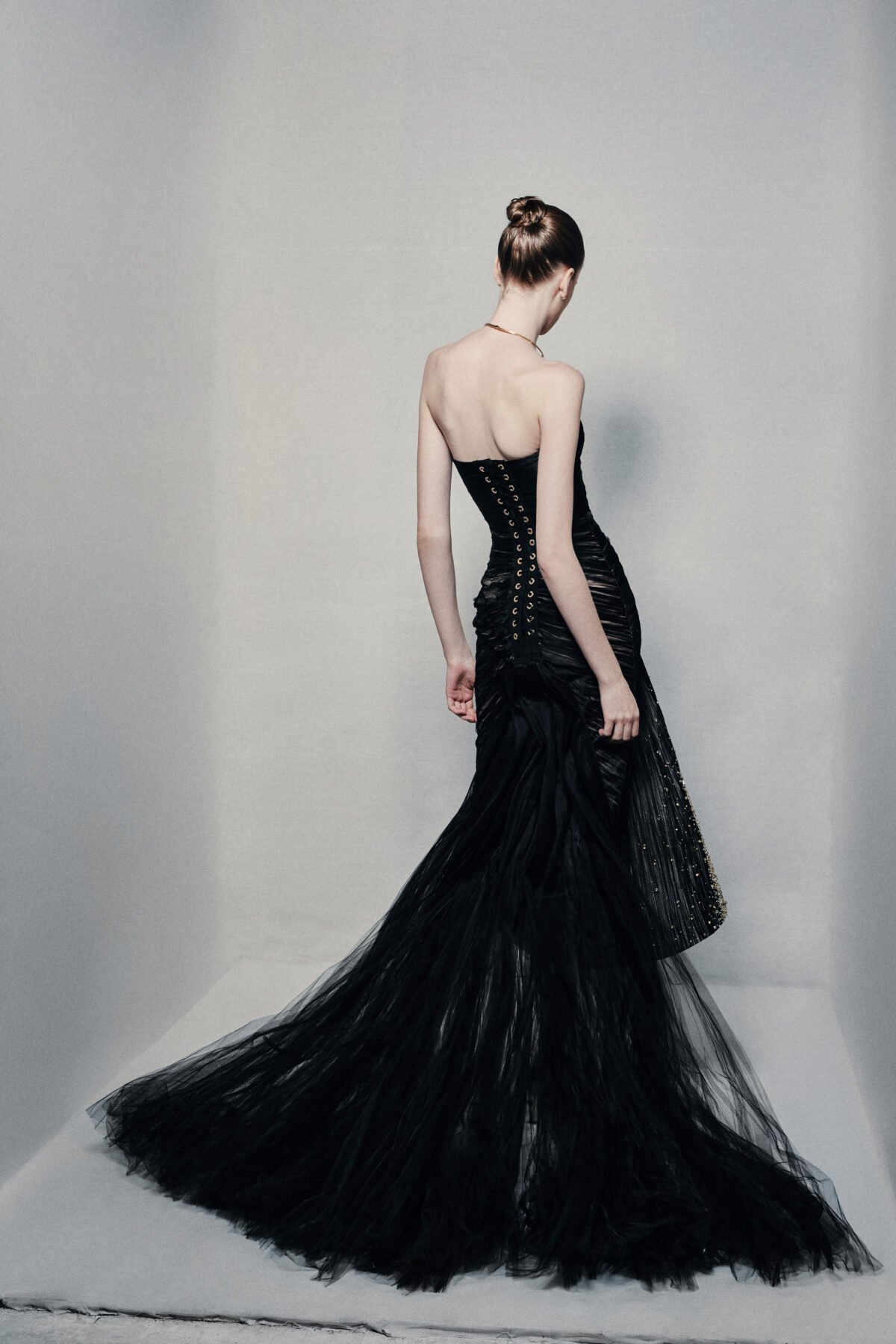 Black strapless mermaid gown with gold embellishments
