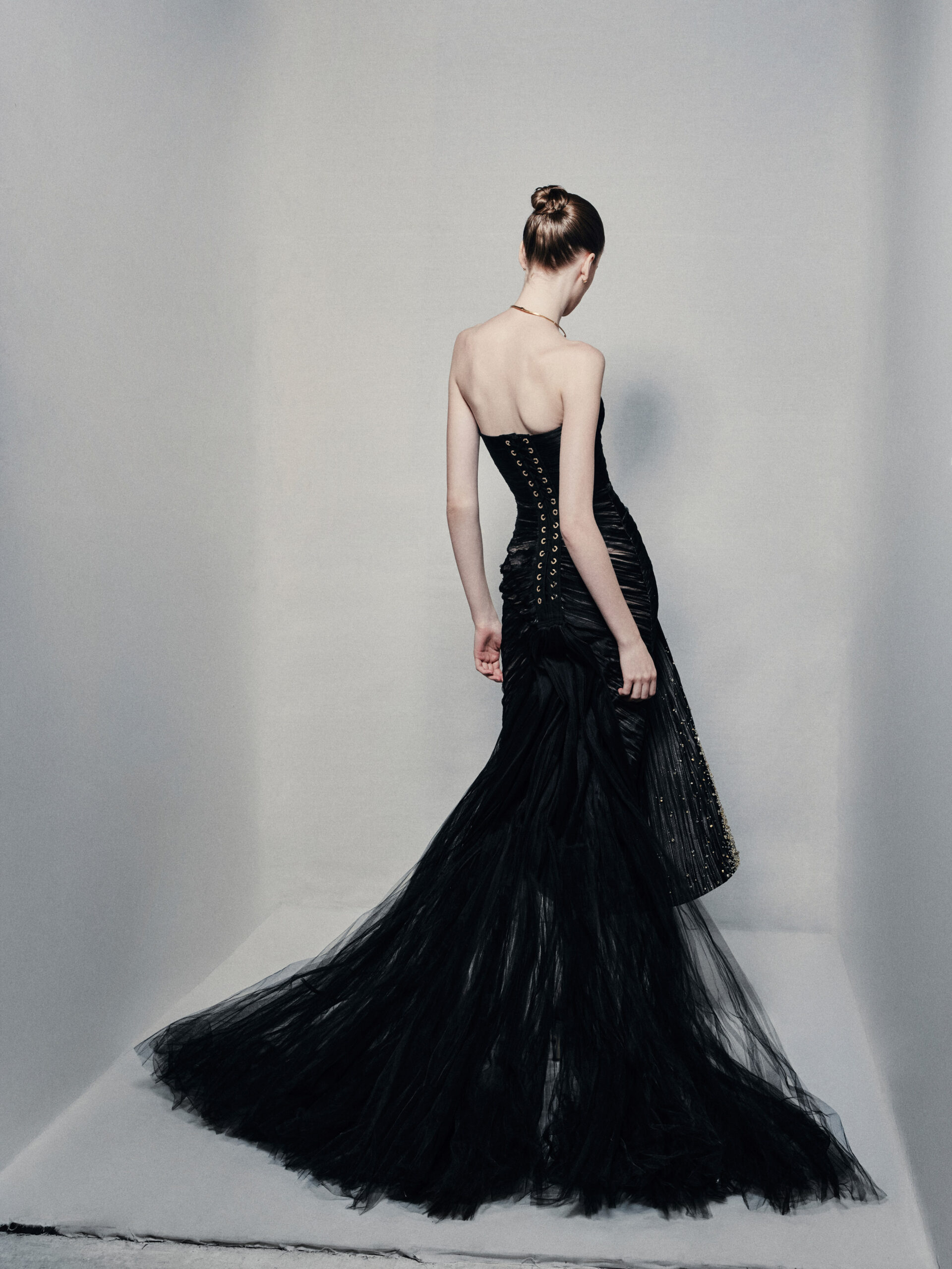 Black strapless mermaid gown with gold embellishments