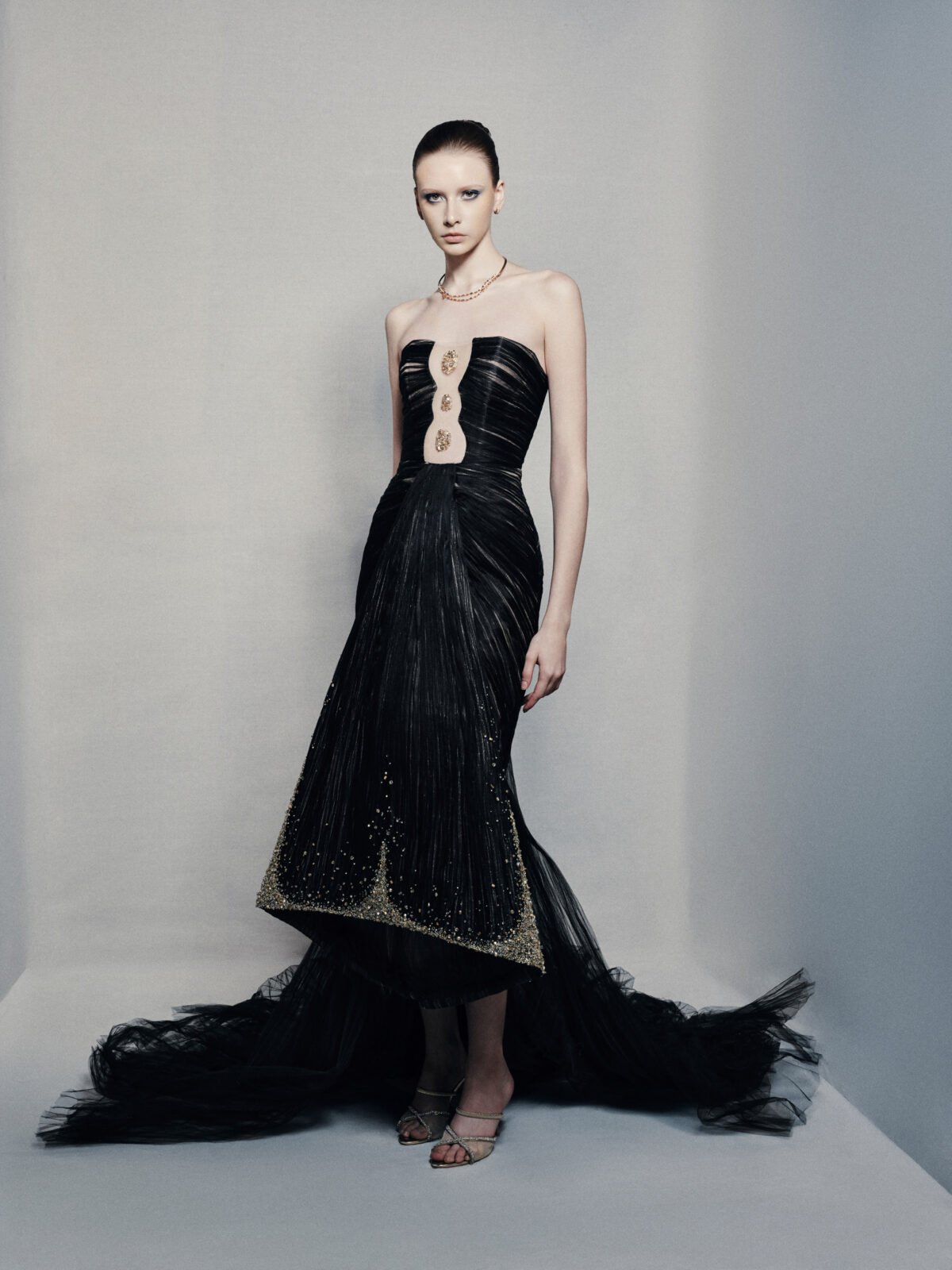 Black strapless mermaid gown with gold embellishments
