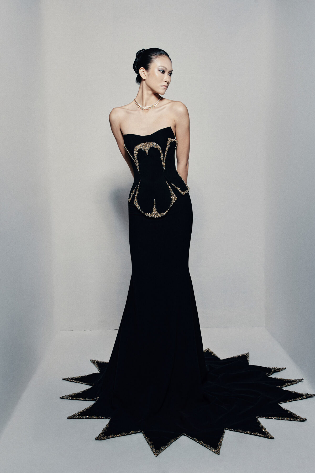 Black strapless fit and flare gown in crepe