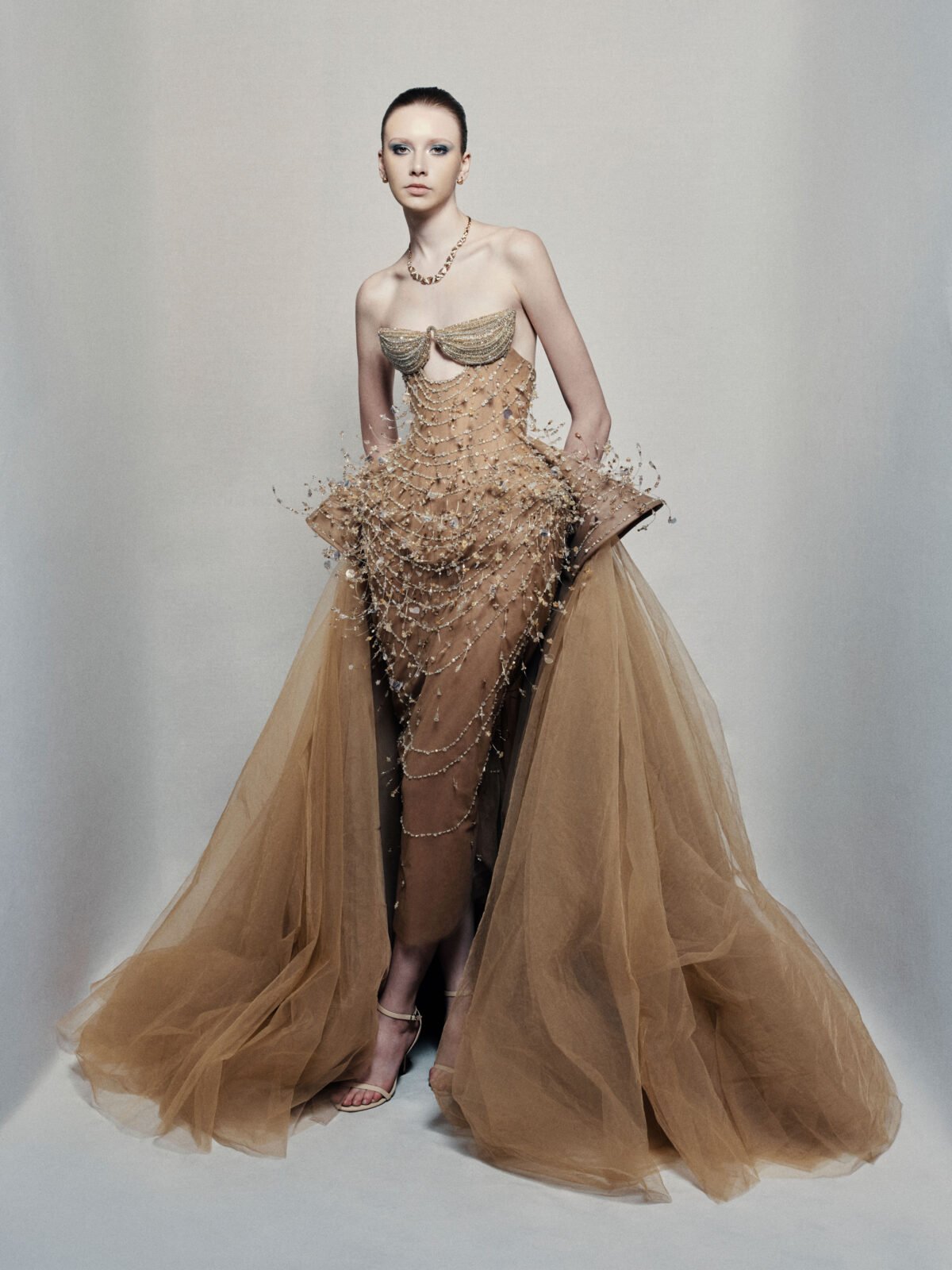 Strapless bronze ball gown with cascading chain beadwork