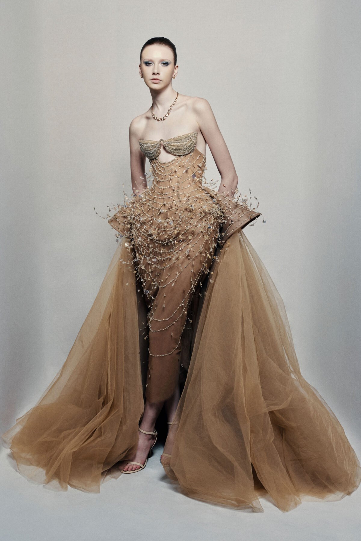 Strapless bronze ball gown with cascading chain beadwork