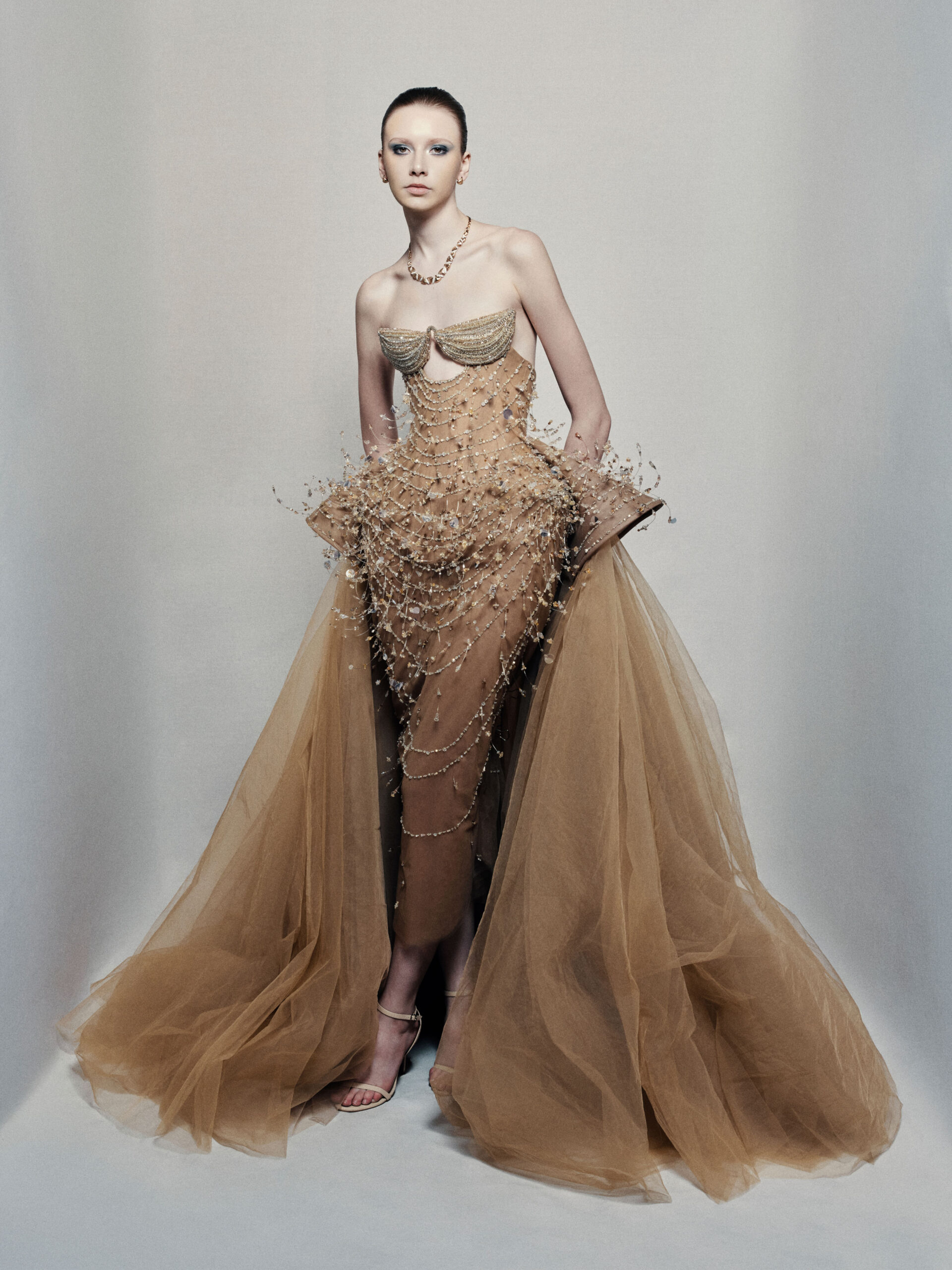 Strapless bronze ball gown with cascading chain beadwork