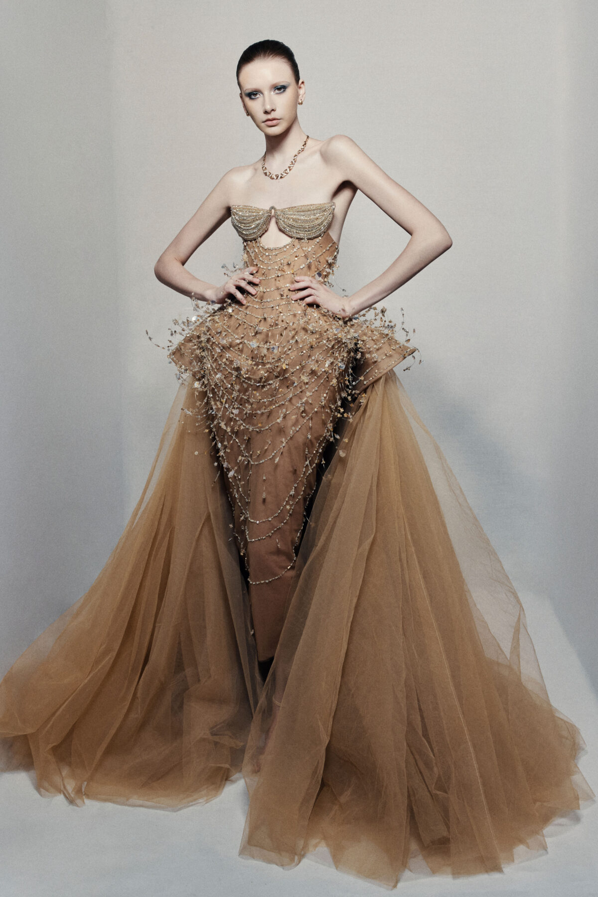 Strapless bronze ball gown with cascading chain beadwork