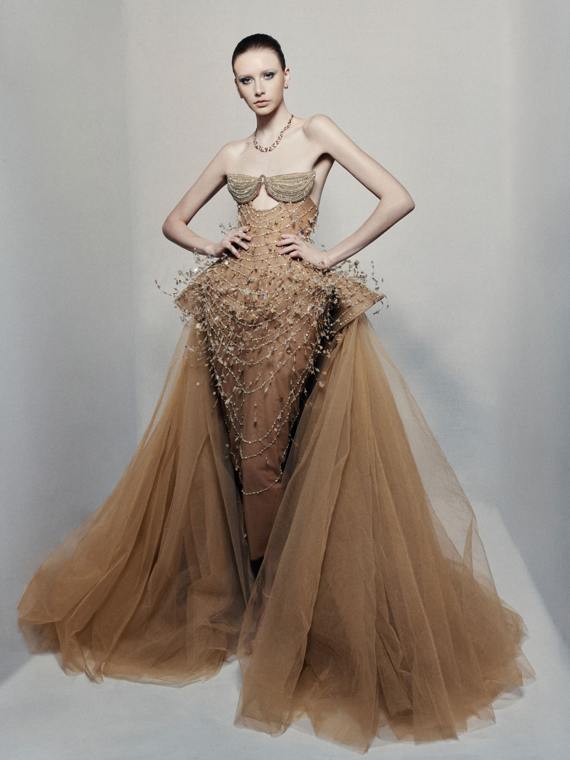 Strapless bronze ball gown with cascading chain beadwork