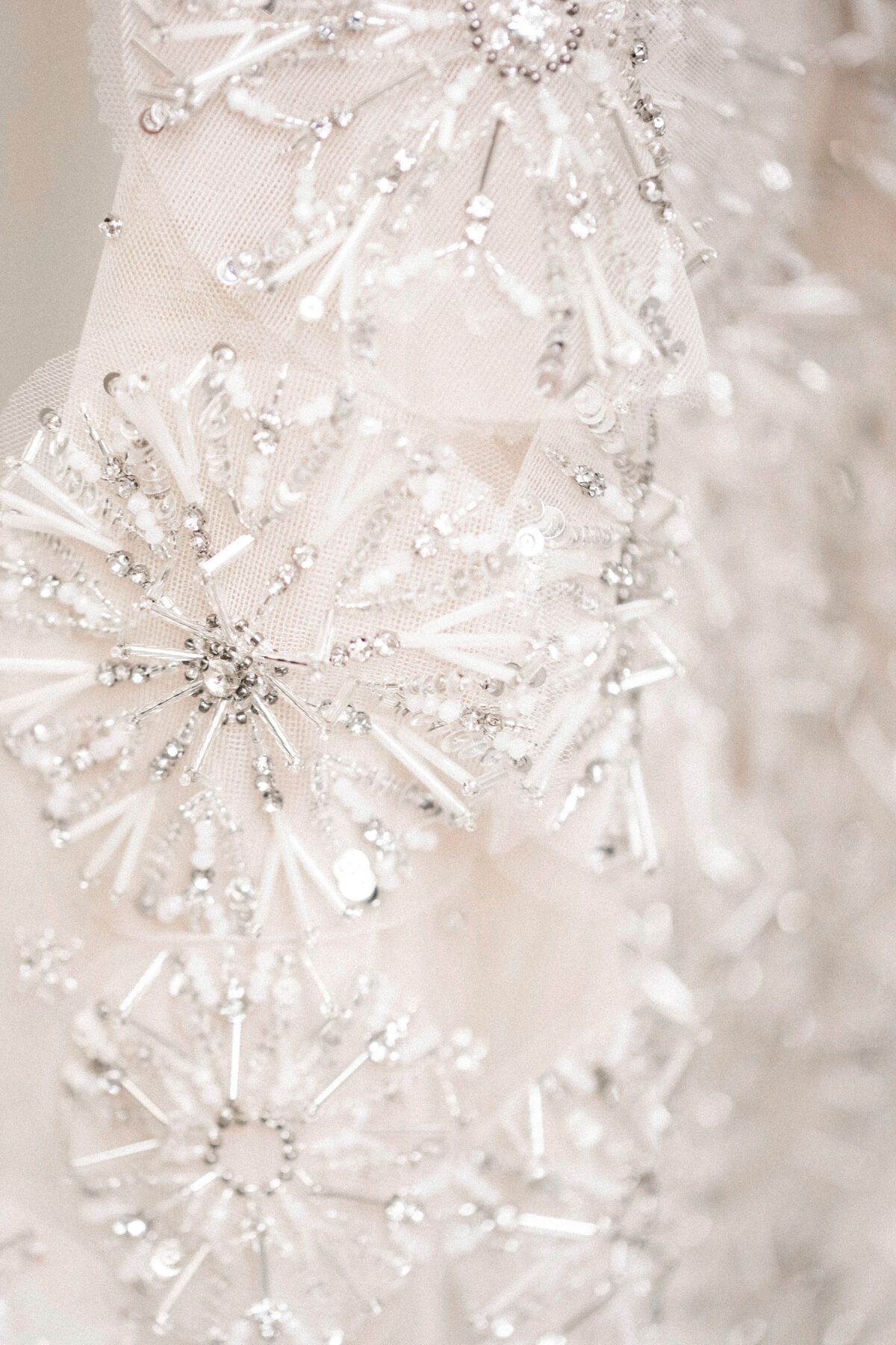 White strapless trumpet tulle gown with 3D crystal dandelion appliqués