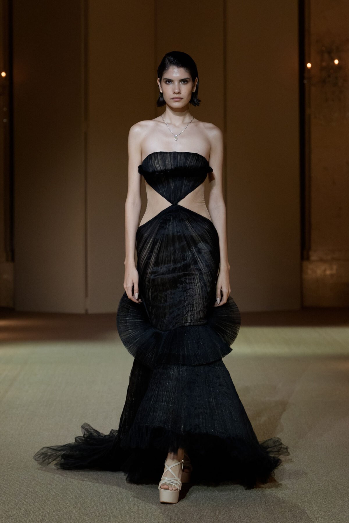 Black strapless mermaid gown with midriff cut-out by PHAN HUY