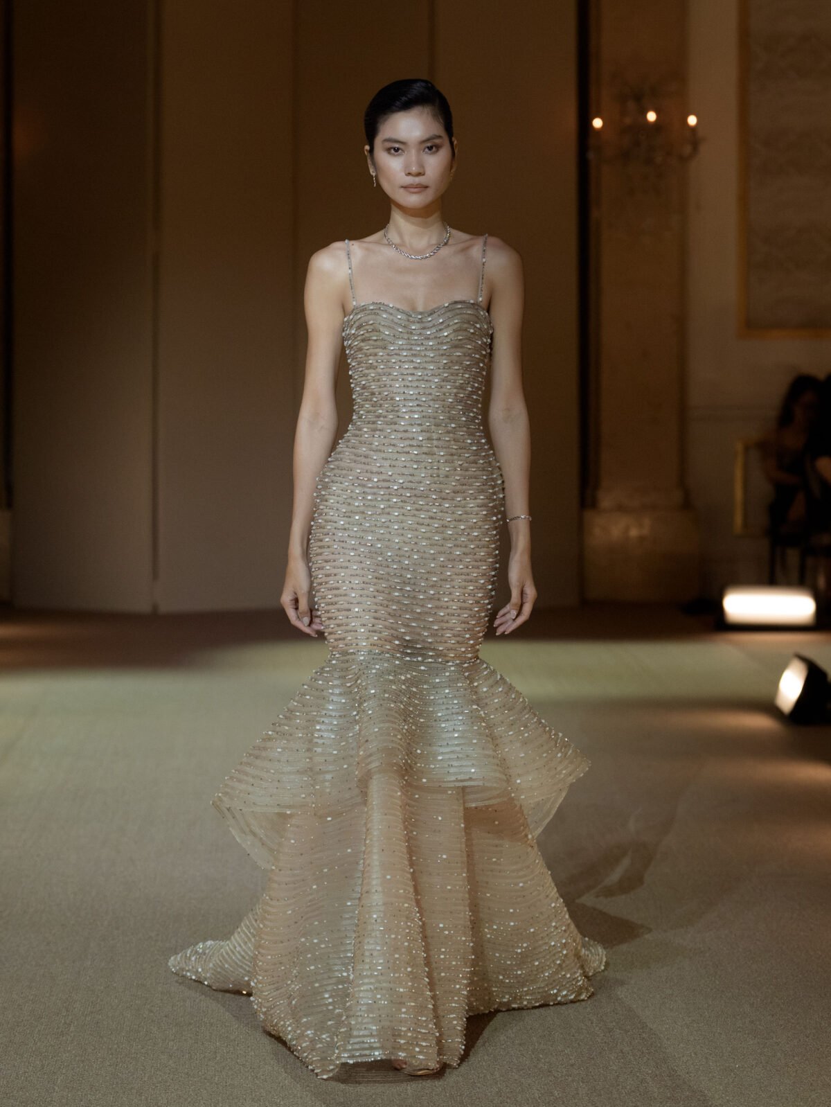 Light taupe trumpet gown with crystal embellished peplum