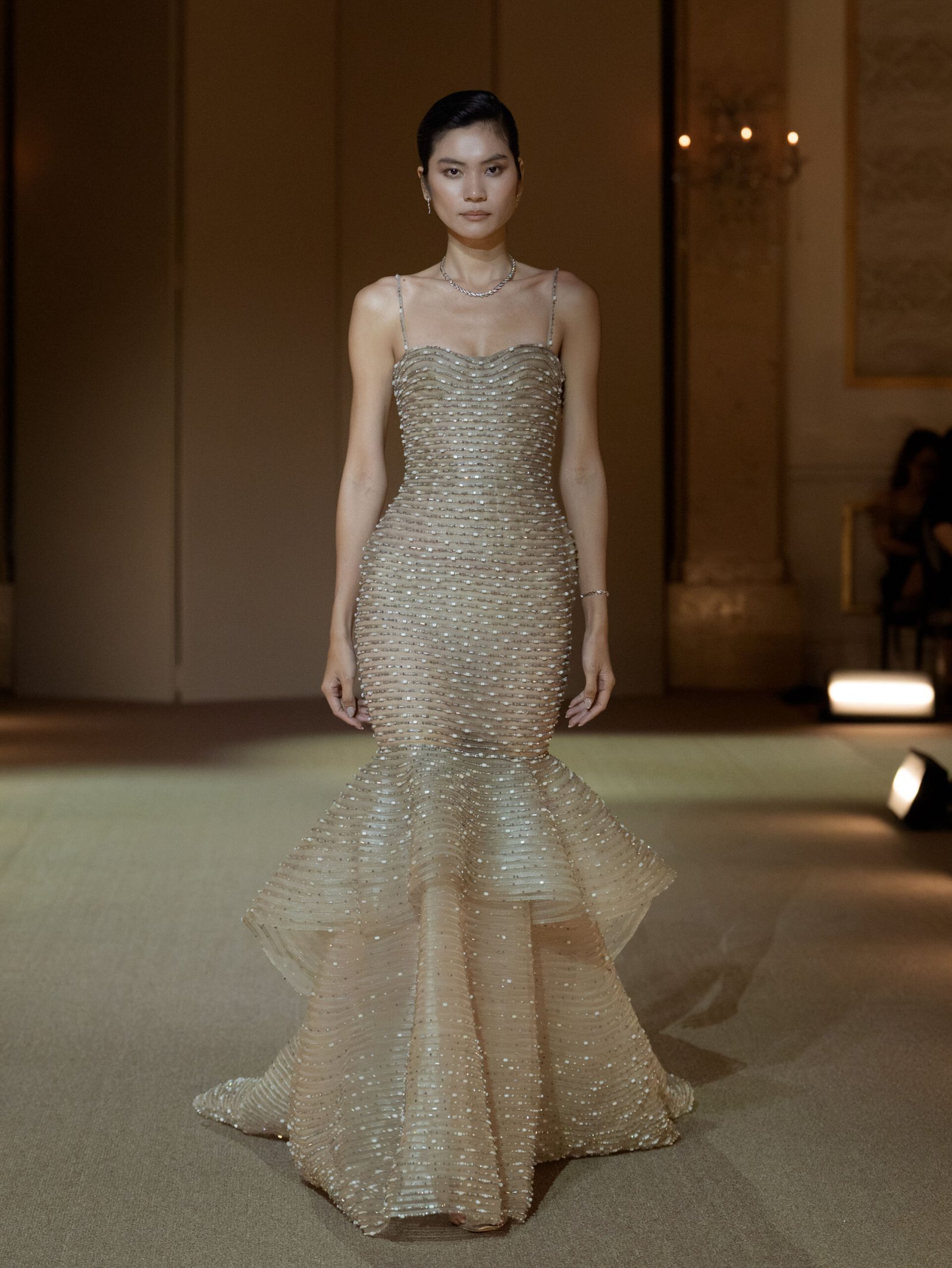 Light taupe trumpet gown with crystal embellished peplum