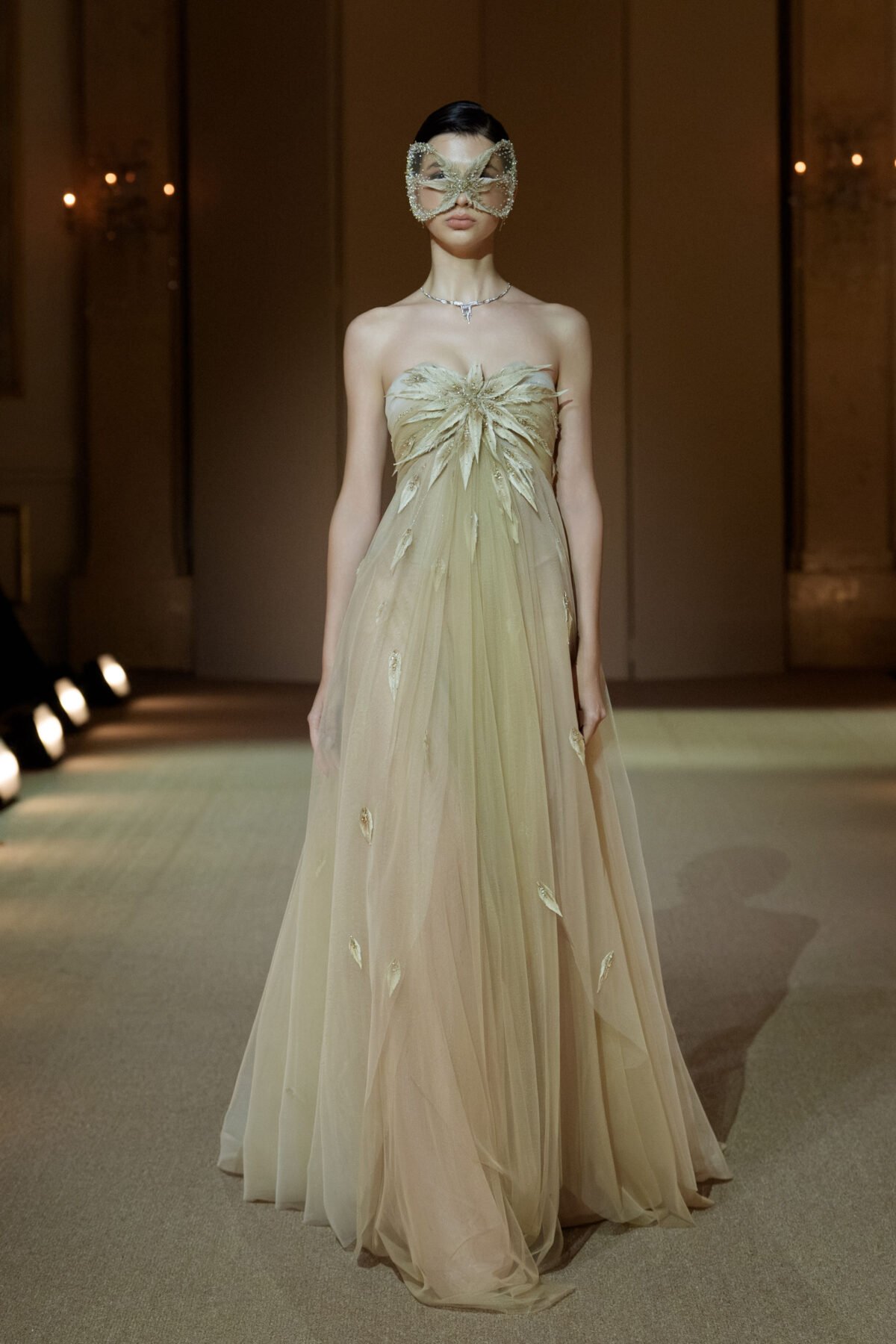 Nude champagne strapless empire-line tulle dress with embellished feathers