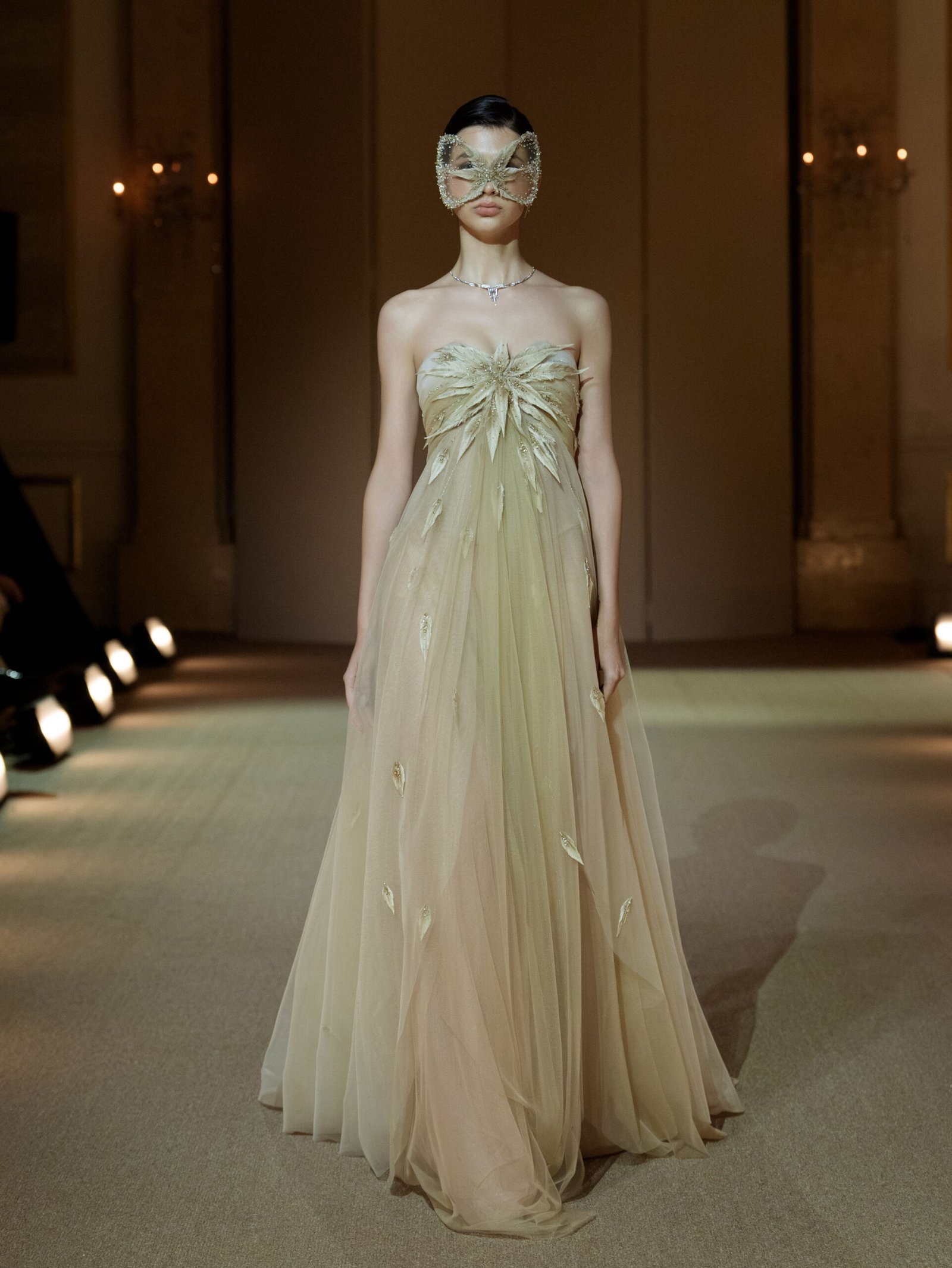 Nude champagne strapless empire-line tulle dress with embellished feathers