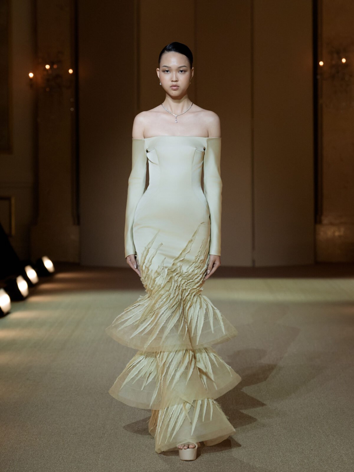 Champagne off-shoulder long-sleeved mermaid gown with a three-tiered skirt