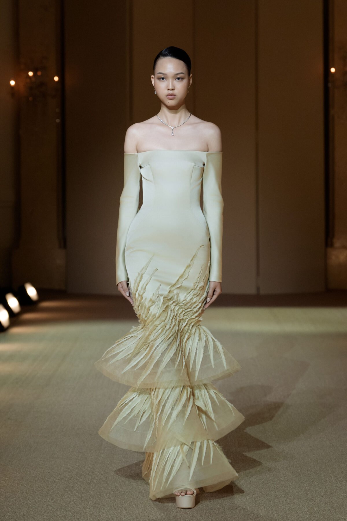 Champagne off-shoulder long-sleeved mermaid gown with a three-tiered skirt