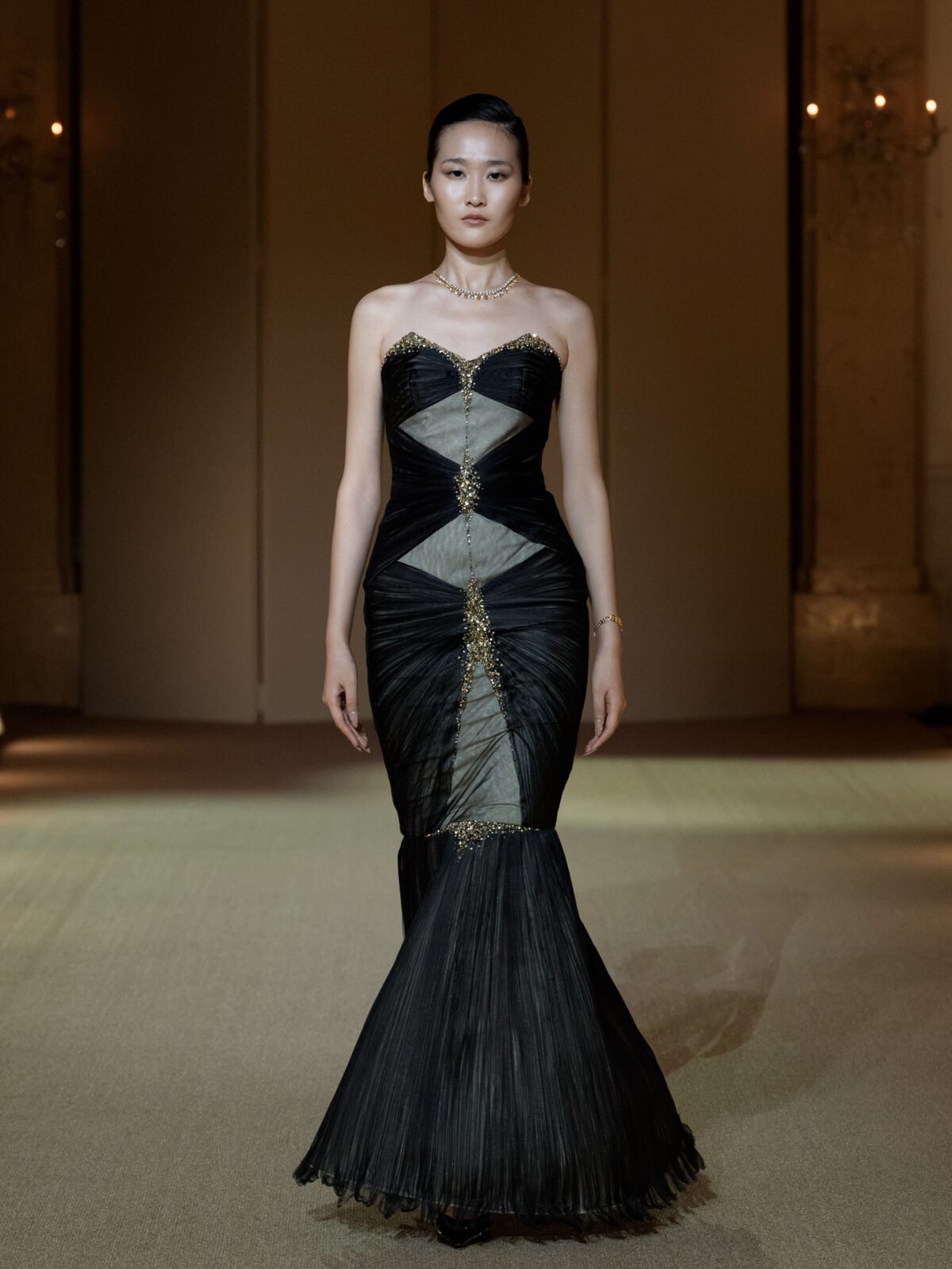 Black strapless mermaid gown with gold bead and rhinestone embellishment
