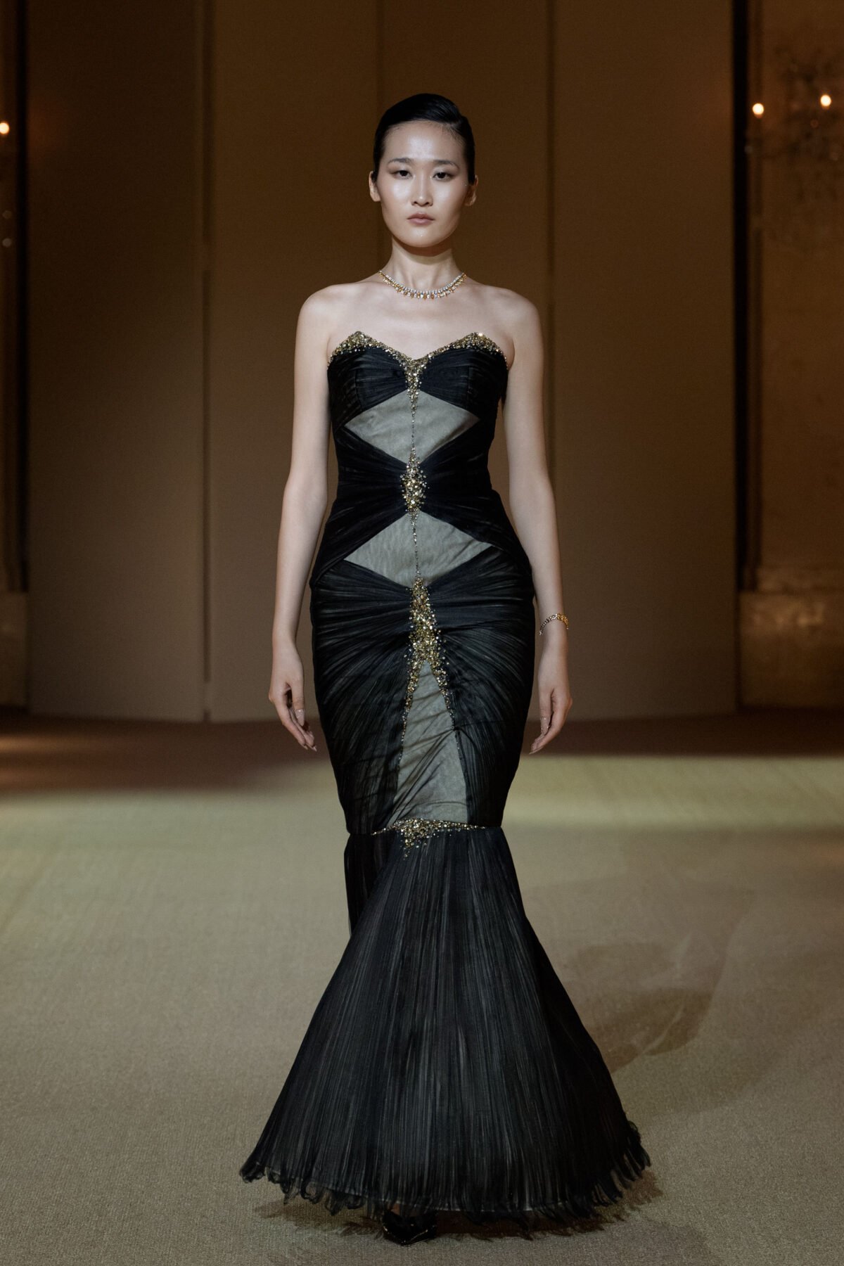 Black strapless mermaid gown with gold bead and rhinestone embellishment
