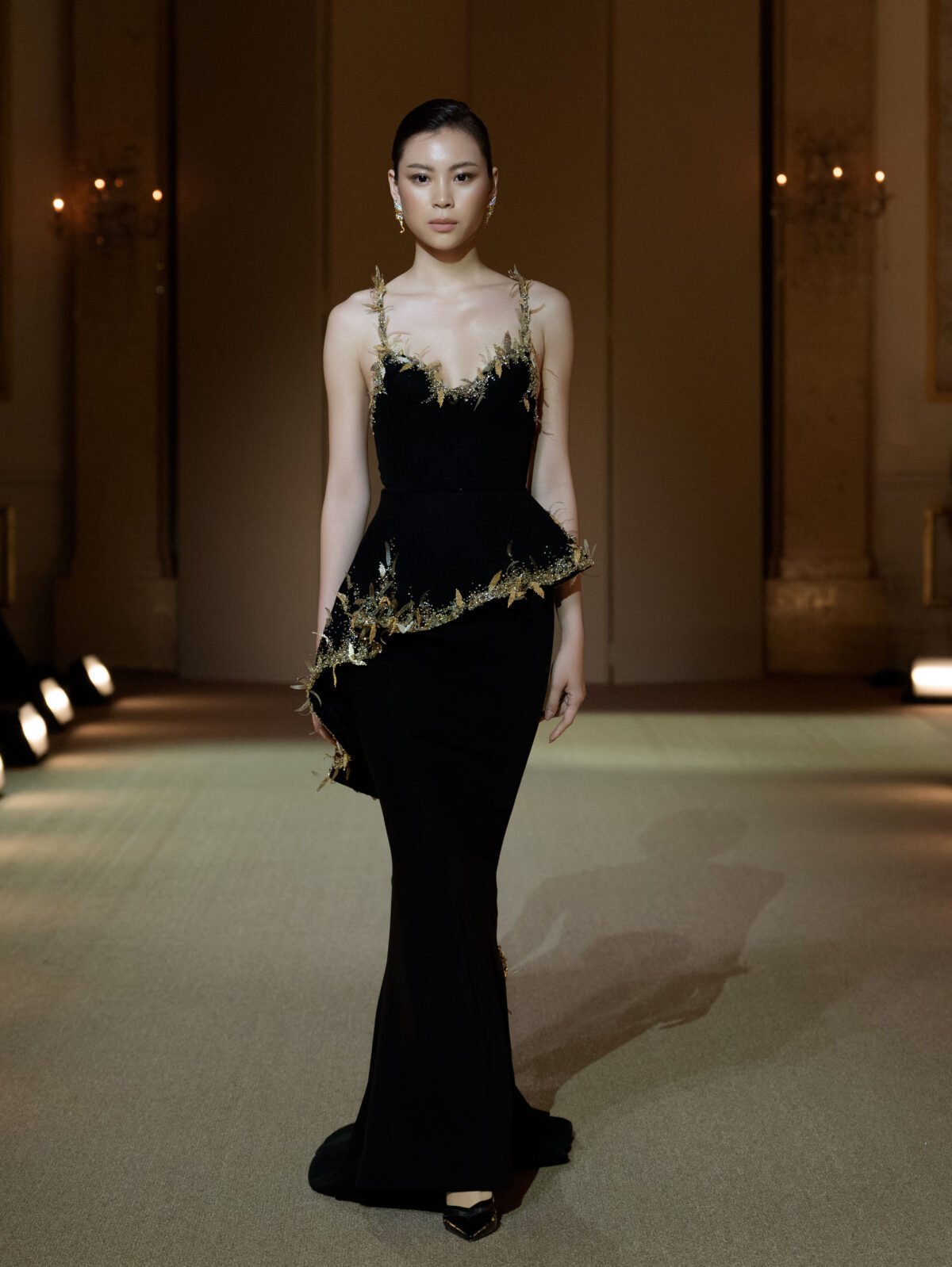 Black trumpet gown with gold beadwork and three-dimensional leaf appliqués