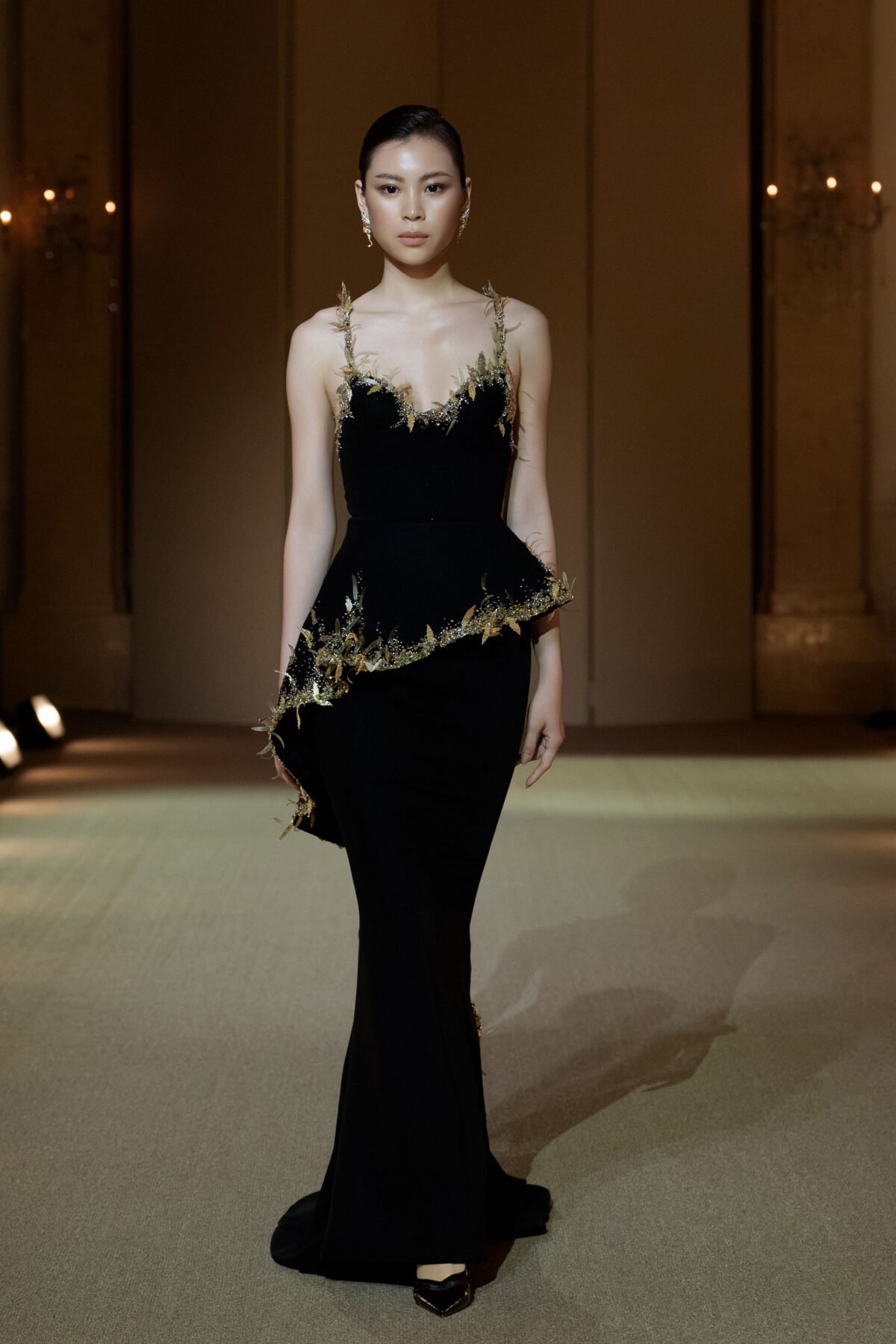 Black trumpet gown with gold beadwork and three-dimensional leaf appliqués