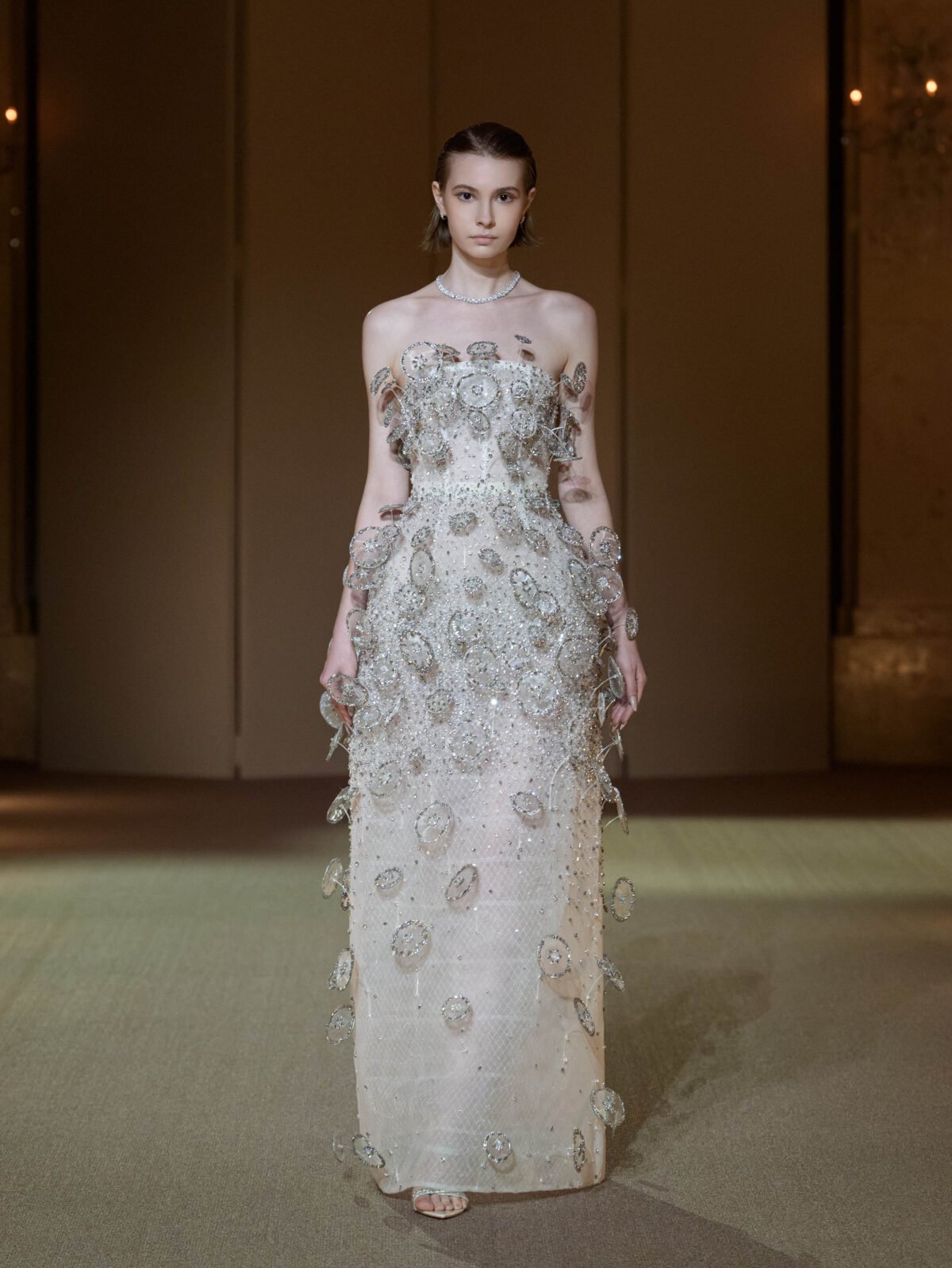 Silvery white column dress with three-dimensional circular disc embellishment
